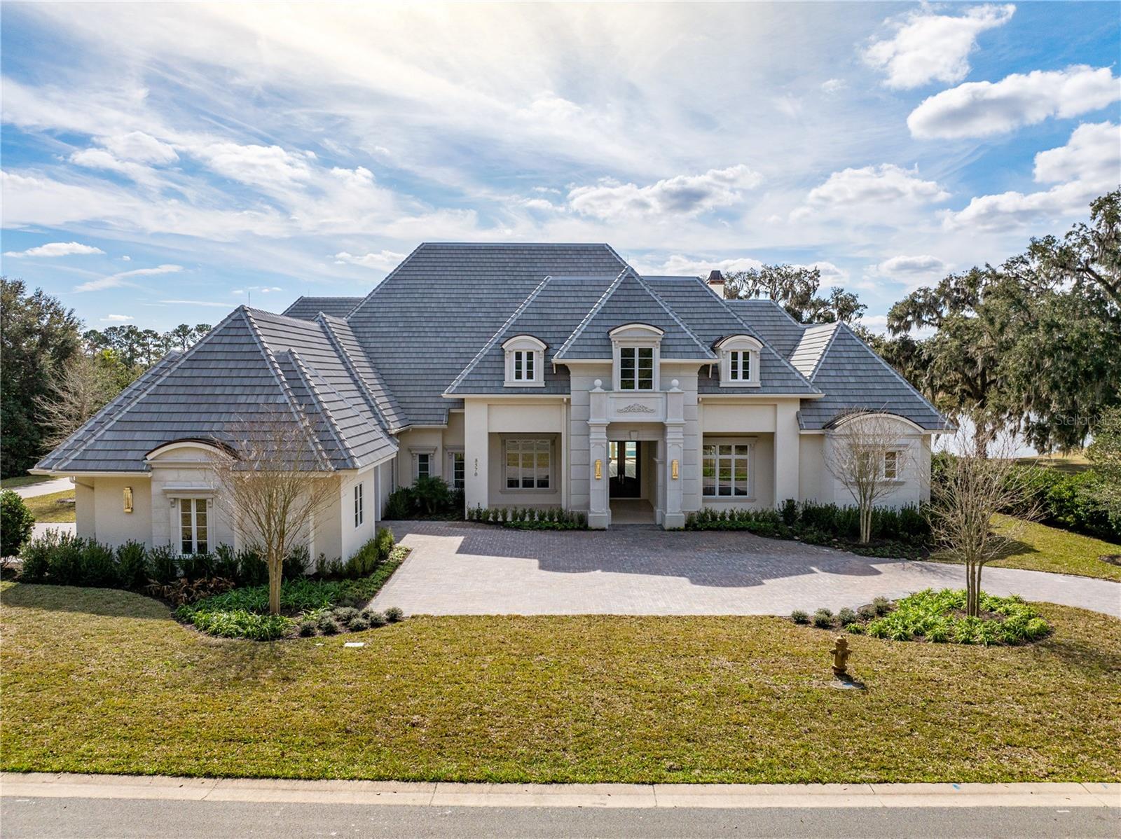 Indulge in luxury living from this impeccable new construction estate by Equestrian Luxury Homes. The award-winning Roberts Design Group, a premier design firm with awards in superior design and luxury categories, tastefully designed this extraordinary home, checking off all the bells and whistles.

Prepare to be impressed as you enter through the foyer with a custom marble design that leads you to the open kitchen adjacent to the living room area and extends to the outdoor living space. The main living area features 18' high ceilings, multilayered crown molding, and baseboards. 

This home is a true sanctuary, offering a blend of luxury, comfort, and technology. Don't let this opportunity pass you by!