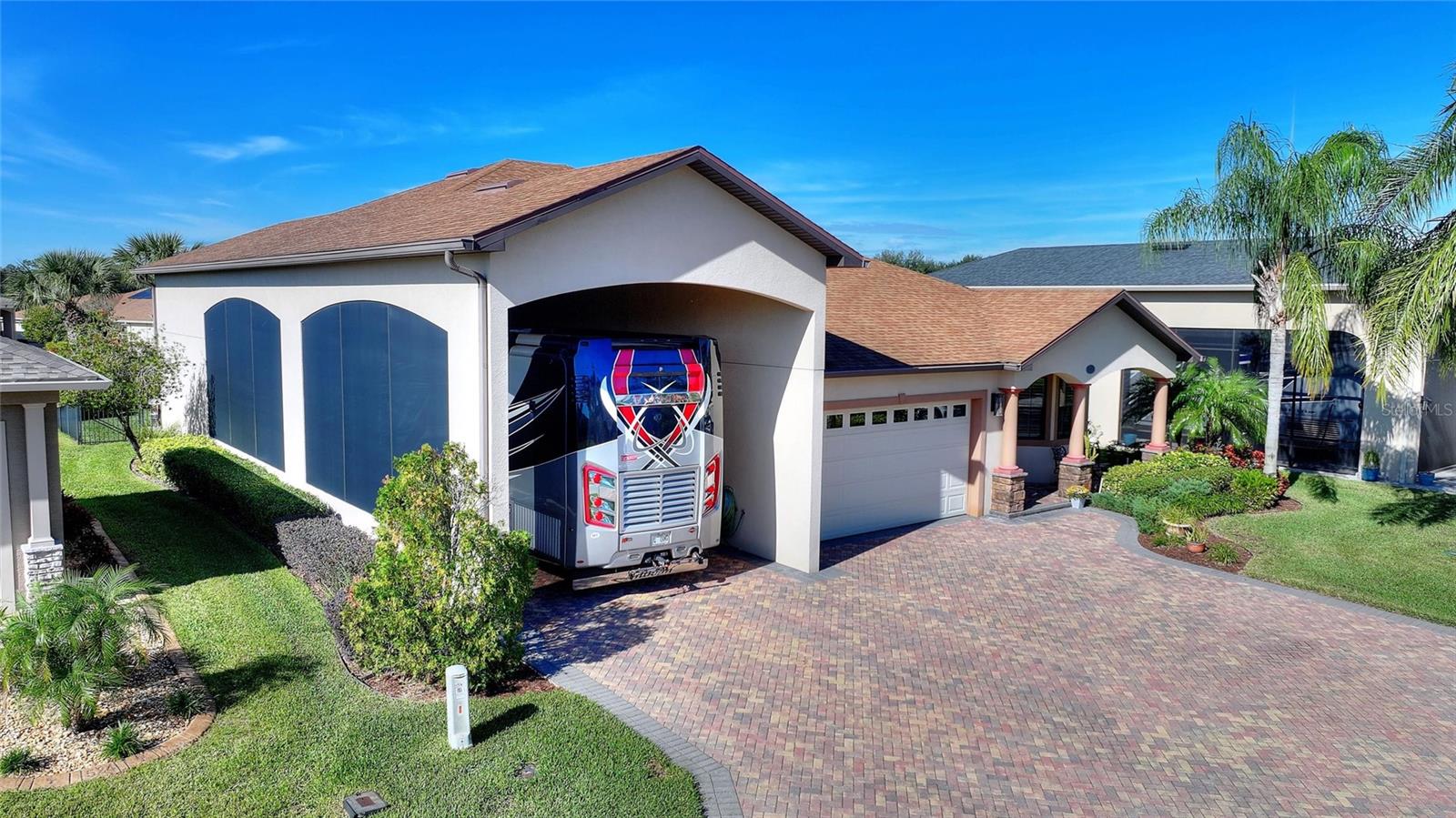 Experience Florida luxury living in this stunning home featuring 2,844 sq.ft. of thoughtfully designed space ideal for entertaining. The gourmet kitchen, a chef's delight, boasts granite countertops, a 17-ft bar, gas stove and oven, a walk-in butler's pantry and an island with a wine refrigerator. Entertain easily in the expansive great room, dining area and Florida room filled with natural light. The luxurious primary suite features a large designer walk-in closet and a shower with two shower heads, and a third bedroom can serve as a den or office. Enjoy a versatile multi-purpose hobby/game room/lounge with storage under the stairs. Also, included are a two-car garage, and an upstairs bonus room with access to a large attic. Outdoor highlights include a fenced backyard and an impressive 52' x 18.7' RV port with dual water connections and sun screens. With a whole-house generator, 250-gallon underground propane tank, gas on-demand water heating system, and energy-efficient appliances, this house offers elegance, comfort and convenience all in one exceptional package. Brand new TRANE HVAC System installed 3/11/2026 with a 5 year warranty.
