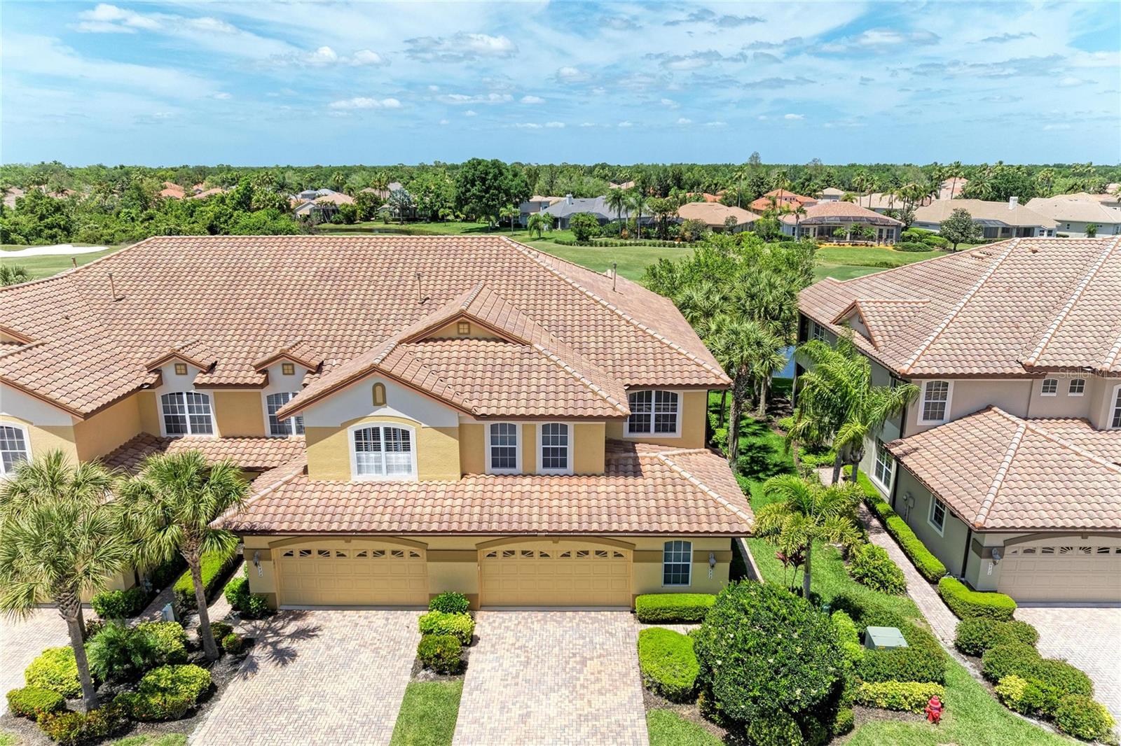 SPECTACULAR VIEWS AWAIT YOU-in this LAKEWOOD RANCH TOWNHOME, experience refined, effortless living in the heart of Lakewood Ranch, perfectly positioned within a maintenance-free enclave along The Links Golf Course. This exceptional three-bedroom, three-and-a-half-bath townhome blends timeless elegance with thoughtful design, offering a spacious and inviting layout complemented by a rare oversized 2.5-car GARAGE—ideal for two vehicles, a golf cart, and abundant built-in storage with custom cabinetry and overhead racks.
Every detail has been carefully curated, from the crown molding that flows throughout the home to the bespoke wainscoting in the dining room and kitchen, creating a warm yet relaxing ambiance. A custom-designed wine nook serves as both a stylish focal point and a functional space for entertaining.
The main living area is light, airy, and beautifully updated, featuring a designer backsplash, under-cabinet lighting, granite countertops, and a generous breakfast bar—perfect for hosting or casual everyday living. Just beyond, a charming bonus space opens to the lanai through double sliders, while the living room’s expansive triple sliders seamlessly blend indoor and outdoor living. Step into the screened lanai to take in tranquil lake views and sweeping golf course vistas—your own private retreat.  Sizeable laundry room for extra storage along with, front load washer & dryer.
Upstairs, a striking wrought iron staircase with wood inlay leads to the second level, where the primary suite offers truly breathtaking, panoramic views of the golf course and lake. The spa-inspired ensuite bath features a large granite walk-in shower, marble-accented soaking tub, and dual vanities designed for both luxury and ease. A spacious custom walk-in closet and a dedicated office provide both comfort and functionality for modern living.
Two additional bedrooms share a well-appointed Jack-and-Jill bath, while an additional bathroom adjacent to the office offers added convenience and flexibility.
Located in the highly sought-after Miramar Lagoon within Lakewood Ranch Country Club, this corner residence is just moments from the community’s amenity center, featuring a heated pool and spa, cabana lounging areas, and a fully equipped fitness center. The HOA ensures a truly effortless lifestyle by covering lawn care, irrigation, and roof maintenance, while also allowing monthly rentals—making this an ideal opportunity for seasonal residents or investors.
Set just off University Parkway, you are minutes from an array of upscale dining and shopping, with the region’s renowned sugar-sand beaches only a short drive away.  Don't wait on this generous size Townhome to call home!