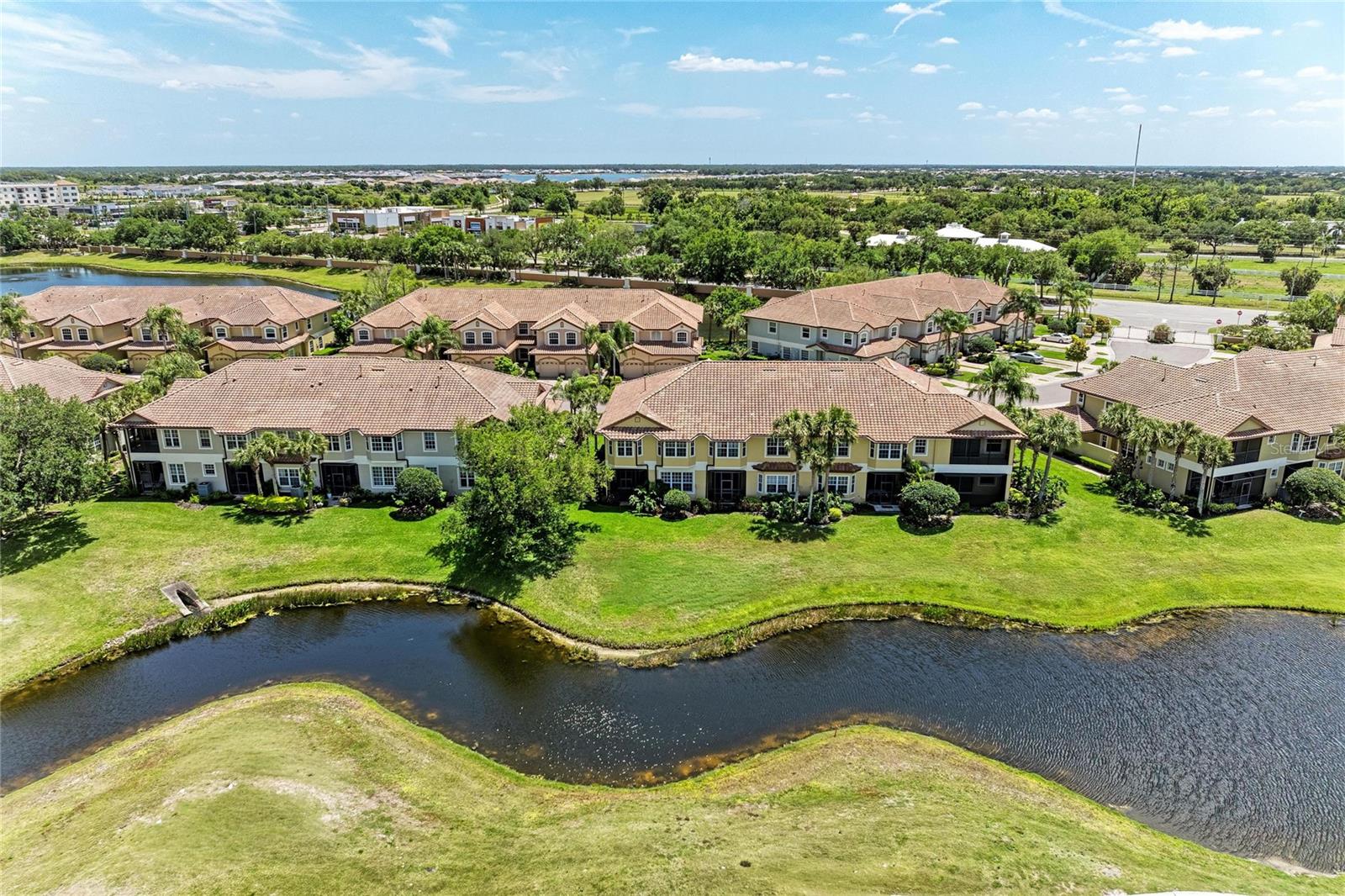 SPECTACULAR VIEWS AWAIT YOU-in this LAKEWOOD RANCH TOWNHOME, experience refined, effortless living in the heart of Lakewood Ranch, perfectly positioned within a maintenance-free enclave along The Links Golf Course. This exceptional three-bedroom, three-and-a-half-bath townhome blends timeless elegance with thoughtful design, offering a spacious and inviting layout complemented by a rare oversized 2.5-car GARAGE—ideal for two vehicles, a golf cart, and abundant built-in storage with custom cabinetry and overhead racks.
Every detail has been carefully curated, from the crown molding that flows throughout the home to the bespoke wainscoting in the dining room and kitchen, creating a warm yet relaxing ambiance. A custom-designed wine nook serves as both a stylish focal point and a functional space for entertaining.
The main living area is light, airy, and beautifully updated, featuring a designer backsplash, under-cabinet lighting, granite countertops, and a generous breakfast bar—perfect for hosting or casual everyday living. Just beyond, a charming bonus space opens to the lanai through double sliders, while the living room’s expansive triple sliders seamlessly blend indoor and outdoor living. Step into the screened lanai to take in tranquil lake views and sweeping golf course vistas—your own private retreat.  Sizeable laundry room for extra storage along with, front load washer & dryer.
Upstairs, a striking wrought iron staircase with wood inlay leads to the second level, where the primary suite offers truly breathtaking, panoramic views of the golf course and lake. The spa-inspired ensuite bath features a large granite walk-in shower, marble-accented soaking tub, and dual vanities designed for both luxury and ease. A spacious custom walk-in closet and a dedicated office provide both comfort and functionality for modern living.
Two additional bedrooms share a well-appointed Jack-and-Jill bath, while an additional bathroom adjacent to the office offers added convenience and flexibility.
Located in the highly sought-after Miramar Lagoon within Lakewood Ranch Country Club, this corner residence is just moments from the community’s amenity center, featuring a heated pool and spa, cabana lounging areas, and a fully equipped fitness center. The HOA ensures a truly effortless lifestyle by covering lawn care, irrigation, and roof maintenance, while also allowing monthly rentals—making this an ideal opportunity for seasonal residents or investors.
Set just off University Parkway, you are minutes from an array of upscale dining and shopping, with the region’s renowned sugar-sand beaches only a short drive away.  Don't wait on this generous size Townhome to call home!