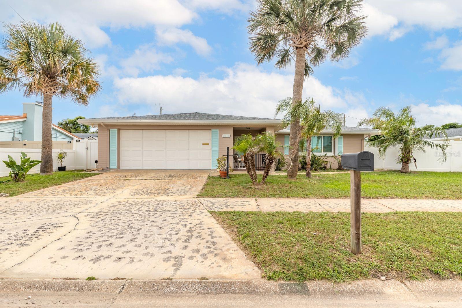 Welcome to this beautifully maintained Beck-built home, ideally located just one block from the beach with convenient beach access and charming neighborhood sidewalks. Built to last in 1969, this property combines timeless character with modern upgrades and exceptional privacy.

Step inside to a welcoming foyer with a spacious closet and discover an inviting floor plan designed for comfortable coastal living. The bright galley kitchen features porcelain countertops, stainless steel appliances, a stylish glass tile backsplash, and a convenient location between the family room and dining area—perfect for entertaining.

The spacious living areas provide flexibility and comfort, while the thoughtfully designed bedroom layout can easily be separated from the main living space to create a private bedroom wing. Both the primary and guest bathrooms retain their mid-century charm while featuring updated quartz countertops, new sinks, faucets, toilet supply lines, valves, and Kohler medicine cabinets.

Enjoy low-maintenance flooring throughout, including luxury vinyl plank, tile, and preserved mid-century tile in the bathrooms.

Step outside to your own private backyard oasis featuring a sparkling pool, hot and cold outdoor shower, and PVC privacy fencing. Whether you’re relaxing after a day at the beach or entertaining guests, this outdoor space is designed for year-round enjoyment.

Additional highlights include impact-resistant windows and sliding doors for added storm protection and peace of mind, plus an oversized 573-square-foot garage equipped with a Chamberlain smart garage door opener and remote-view camera.

Major updates include:
• Roof (2020)
• Water Heater (2020)
• Pool Pump & Timer (2020)
• A/C (2018)
• Septic System (2017)
• Electrical Panel (2017)
• Exterior Paint (2021)
• Interior Paint (2025)

This move-in-ready beachside retreat offers the perfect combination of location, privacy, quality construction, and modern updates.