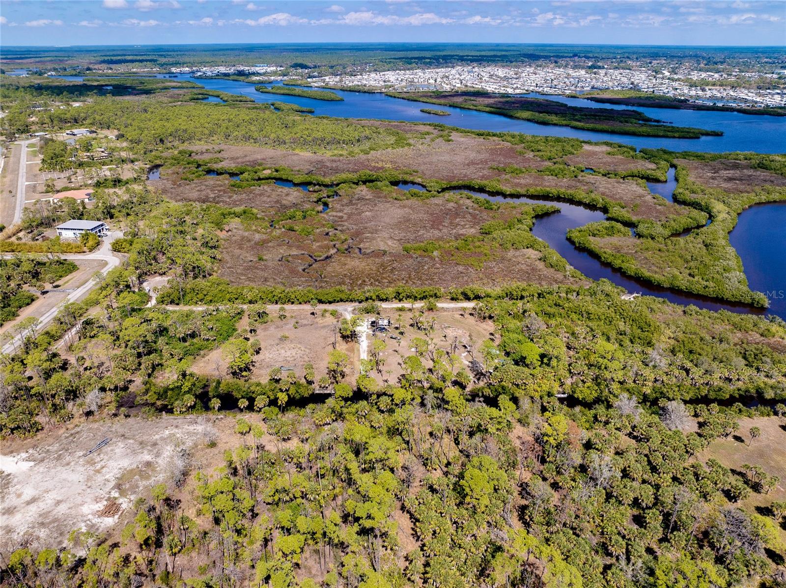 An extraordinary opportunity awaits, over 17 acres of untouched land set along the scenic Myakka River, complete with your own private island. This rare offering combines expansive acreage, riverfront beauty, and exceptional privacy in one of Southwest Florida’s fastest-growing and most desirable areas.

Perfect for nature lovers, outdoor enthusiasts, or those seeking a secluded private estate or multi-generational family compound, this property offers the space and serenity to create something truly special. Imagine waking to river views, abundant wildlife, and the peaceful sounds of Old Florida, all while being just minutes from modern conveniences.

Located near Wellen Park, the property is approximately 3 miles from CoolToday Park, the spring training home of the Atlanta Braves, about 2 miles from Wellen Park High School, and roughly 3 miles from Downtown Wellen Park’s shops, dining, and community events. The area also offers excellent medical facilities, a variety of golf courses for every skill level, and convenient access to the world-famous Gulf Coast beaches in Venice and Manasota Key, including Manasota Beach.

This remarkable property offers a sense of scale, privacy, and natural beauty that is becoming increasingly scarce in the Venice and Wellen Park area. Whether envisioned as a secluded waterfront estate, a private retreat immersed in nature, or a future family compound to be enjoyed for generations, this offering represents a rare chance to secure a truly distinctive piece of Southwest Florida landscape.