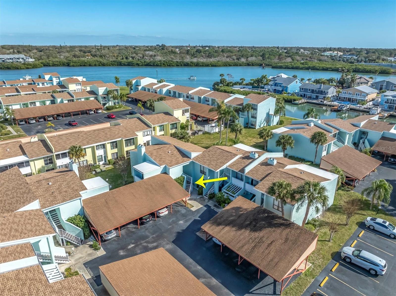 One or more photo(s) has been virtually staged. Experience coastal living at its finest in this rarely available, ground-floor corner condo located in the well appreciated Intracoastal community of Windrush Cove. This thoughtfully updated 3-bedroom, 2-bathroom residence offers a bright, open-concept layout designed for both relaxation and effortless entertaining. The interior features a spacious living room centered around a cozy fireplace, with sliding glass doors that lead to a serene sunroom. The updated kitchen and dining area also boast direct outdoor access, creating a seamless indoor-outdoor flow perfect for hosting guests. Enjoy the convenience of the covered parking carport and a prime location near the powdery sands of the Gulf. Residents are close to the vibrant restaurants, entertainment, and nightlife of Indian Rocks Beach. Whether you are looking for a full-time residence or a seasonal retreat, this turnkey property is a rare find in a highly sought-after community. A few photos were virtually staged to highlight layout and design possibilities.