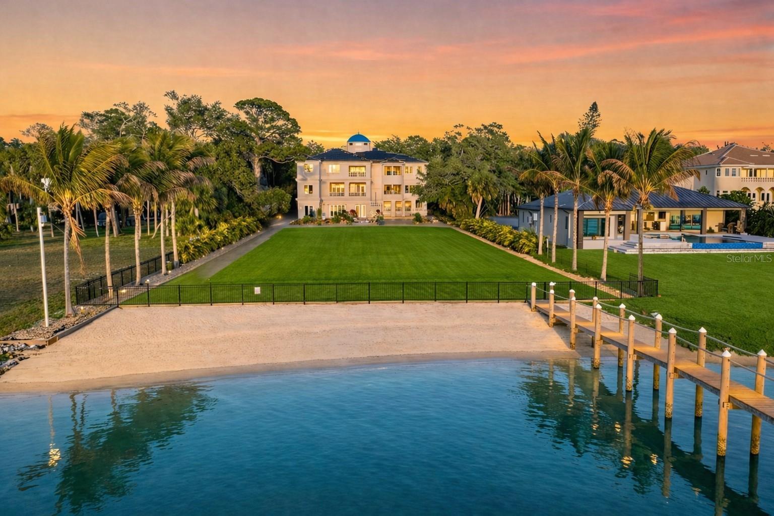 Palazzo Sul Mare is a rare waterfront estate in St. Petersburg's coveted Jungle Prada neighborhood, offering over 19,000 square feet under roof and more than 10,000 square feet of interior living space on more than 1.5 waterfront acres along the Intracoastal Waterway. With a private sandy beach, deep-water dockage, direct Gulf access, and western sunsets, this extraordinary estate is the very definition of a Palace on the Sea.
Built in 2020, the residence blends modern construction with timeless European-inspired design.   
A grand motor court and porte-cochère create a secure, estate-style arrival. An imported limestone exterior, along with wrought iron detailing, a striking dome, a grand cherub fountain, marble statuary, and mature oak trees, establishes a timeless setting surrounded by tropical landscaping and the neighborhood’s iconic peacocks. Inside, a dramatic domed rotunda crowned by a crystal chandelier anchors the home, featuring inlaid marble flooring and dual sweeping marble staircases. The layout captures water views throughout, with a gallery-style corridor ideal for art and entertaining.  Marble archways, columns, iron balustrades, and illuminated art niches enhance the home's scale and architectural presence. 
Custom millwork, fresco-style ceilings, and imported marble flooring span all three levels. The kitchen features a full suite of Thermador appliances, including a 60-inch gas range, integrated refrigeration, and built-in coffee system, along with quartzite surfaces and an illuminated onyx island. A custom Chihuly-style installation of hand-blown glass creates a focal point above, while the curved glass dining area frames panoramic water and pool views with space for entertaining.  
The residence includes five bedroom suites, several exceeding 1,000 square feet, with spa baths and private lanais.  The main-level primary suite offers a marble bath with Phylrich fixtures, sauna, soaking tub, multiple vanities, and panoramic water views beneath a custom fresco ceiling. A private office on the main level features paneled walls, built-ins, an ornate stone fireplace, and balcony access. The upper level includes a club-style lounge with a quartzite waterfall-edge bar and sunset views. The home spans three levels with elevator access and marble staircases, with laundry rooms on multiple levels. 
Outdoor living includes a zero-entry pool, lap pool, two spas, 5 covered terraces, courtyards, fire pit, private sandy beach, citrus trees, and a wide rear lawn.  The grounds offer flexibility for a guest house, sport court, cabana, or greenhouse.  The private dock includes a 10,000-lb lift, additional lifts for personal watercraft and tenders, a wet slip for a yacht, and direct Gulf access.  
Built with longevity and resilience in mind, the residence features reinforced pier-and-beam construction on pilings, impact-rated windows and doors, a stone exterior, and elevated living spaces. With portions of the estate located within a desirable non-flood zone and no history of water intrusion, Palazzo Sul Mare offers both confidence and peace of mind.  
Smart home technology, security cameras, solar power, four HVAC systems, and two whole-house generators enhance comfort and reliability.  Garage capacity for more than six vehicles includes over 5,000 square feet of flexible lower-level space ideal for a workshop, fitness center, recreation room, or additional storage.  Palazzo Sul Mare truly lives up to its name—Palace on the Sea.