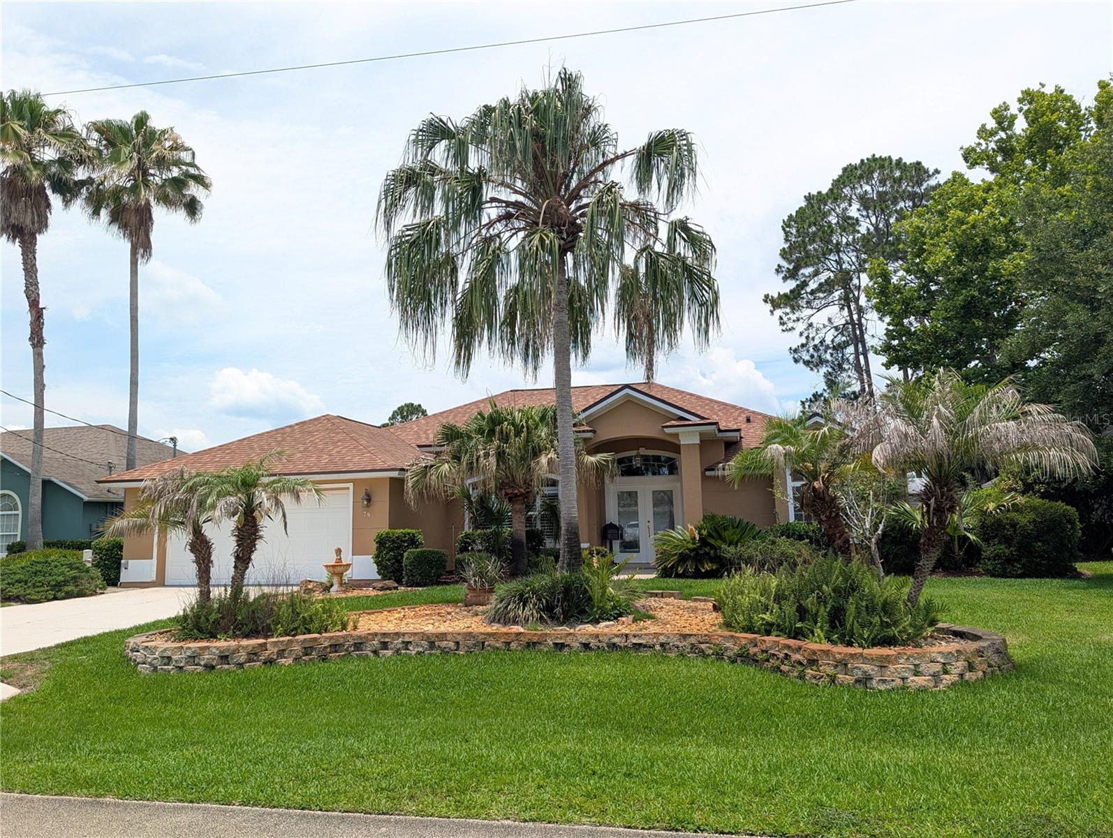 Welcome to your own private Florida retreat! This beautifully designed 3-bedroom, 2-bath home offers the perfect blend of comfort, elegance, and functionality. From the moment you arrive, you’ll appreciate the mature landscaping, impressive etched glass double door entry, and inviting curb appeal. Step inside to discover an open and spacious split floor plan featuring coffered and tray ceilings, decorative niches, formal dining area, and a cozy breakfast nook perfect for casual dining. The large living room opens beautifully to the outdoor oasis through triple sliding glass doors, creating seamless indoor and outdoor living. The spacious primary suite is a true escape featuring a large bedroom, walk-in closet, double sinks, relaxing soaker tub, and a walk-in shower in the primary bath. Outdoors, enjoy your own private paradise with a sparkling swimming pool enhanced by solar panels, making this backyard both enjoyable year-round and energy efficient. The pool area truly feels like an oasis — perfect for entertaining or simply relaxing and enjoying the Florida lifestyle. Conveniently located close to grocery stores, shopping, schools, and the hospital, with the beach just approximately 15 minutes away. Florida living at its best!