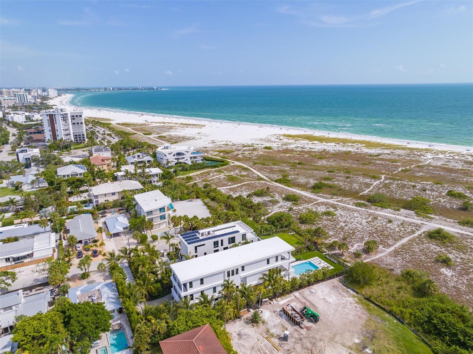 Gulf Front Luxury Living is at its Absolute Best in this Exquisite Estate in the Heart of Lido Key! It will be love at first sight when you enter this stunning newly-constructed 5 Bedroom, 5.5 Bathroom Gulf Front Estate. This home has it all including endless views of The Gulf of Mexico. With over 5,700 square feet under air, this home features Control I4 smart home automation, expansive living spaces with custom, designer finishes, 34 in-ceiling speakers, custom built-ins and motorized Lutron blinds throughout. First, enter through the Grand Foyer where you will be mesmerized by the breathtaking views of the sparkling waters of the Gulf of Mexico. Next, take the master staircase or commercial-grade elevator to the open-concept, main living area which features an oversized, luxurious living room with views of the crystal blue waters of the Gulf as you look out through the floor-to-ceiling, pocket sliding doors containing the highest quality windows. The main living level also features a gorgeous Gulf front dining room, detailed gourmet chef's kitchen featuring Sub Zero and Wolf appliances, separate walk-in pantry, conversation full bar sitting area with a walk-in, temperature-controlled wine room and a custom outdoor kitchen on the lanai. Then, continue up the grand staircase to your private hideaway master suite which includes an oversized bedroom, sitting and lounge area, balcony, walk-in designer closet, large designer bath area with spectacular finishes and, of course, more amazing Gulf views! This floor also features two additional guest suites with a separate den/lounge area for those suites.  Back on the ground level, the expansive Gulf-front swimming pool and enormous surrounding deck offers significant, additional entertaining space. The huge pool has a central, negative-edge spa. The pool deck also features a lounging/dining areas, another custom outdoor kitchen and large activity area covered in all-weather, no maintenance professional turf. Professional landscaping placed with privacy in mind, a 6-car garage and a paved driveway with plenty of room for both owner and guest vehicles. All of this and you are a short stroll from the shops and restaurants of St. Armands Circle.  Call me today to make your dream of owning an exquisite, luxurious Gulf-front Estate a reality!