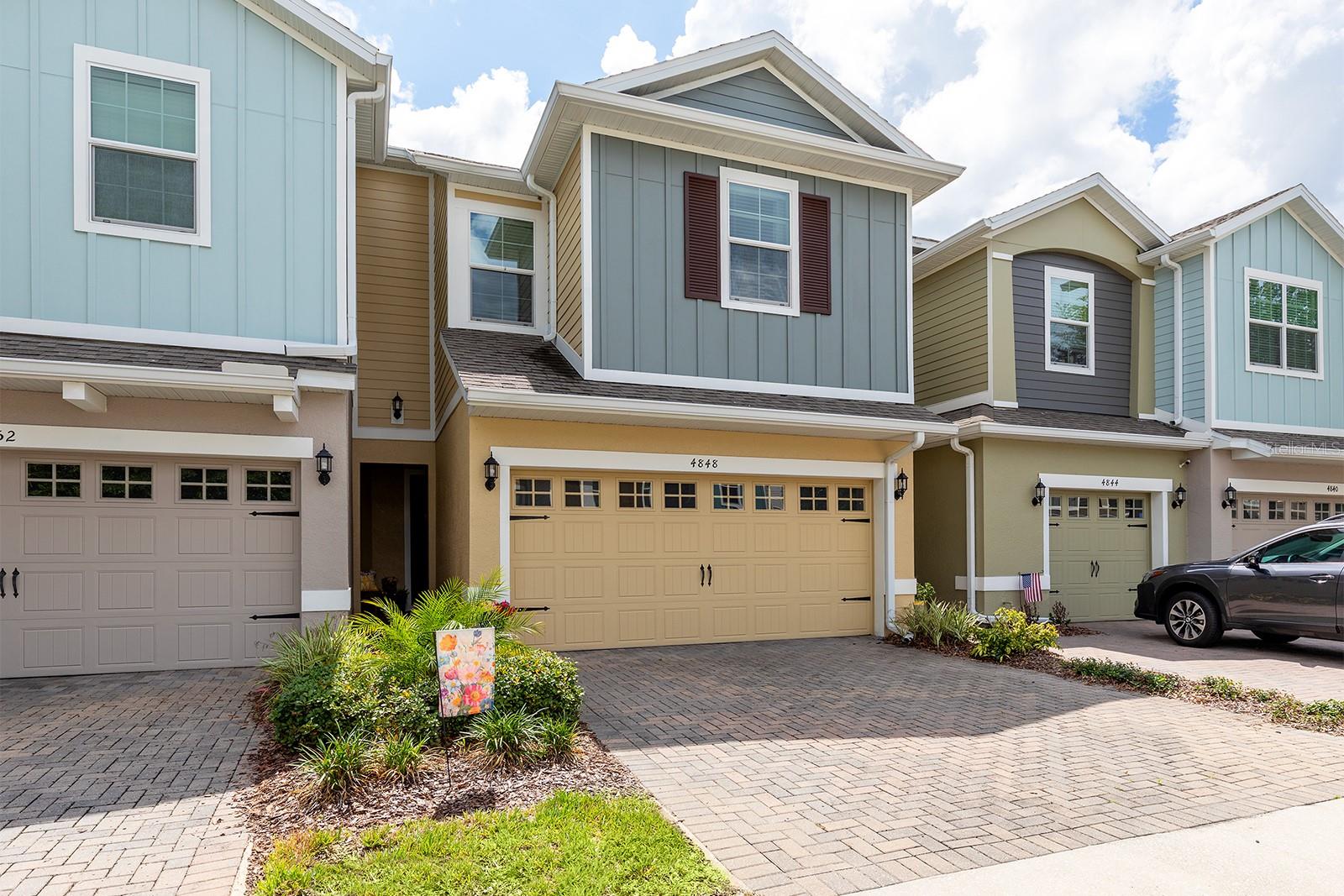 Welcome home to this beautifully maintained 3-bedroom, 2.5-bath townhome with a 2-car garage, ideally located in the popular Lake Mary/Sanford area. Nestled within a charming, tree-lined community surrounded by lush green space, this home offers both privacy and convenience.  The open-concept floor plan is light, bright, and perfect for everyday living and entertaining. The stylish kitchen features granite countertops, light cabinetry, stainless steel appliances, pantry, and a large center island with breakfast bar seating. The adjacent dining area opens to a screened porch overlooking a peaceful green space, creating the perfect setting for morning coffee or evening relaxation.  The spacious living room flows seamlessly into the kitchen and dining areas, making it easy to gather with family and friends. The first floor also includes a convenient half bath, a dedicated office nook ideal for working from home, and additional storage space under the stairs.  Upstairs, the primary suite offers a generous walk-in closet and a private en-suite bath with dual vanities and a walk-in shower. Two additional bedrooms, a full guest bath, and a bright upstairs laundry room provide comfort and convenience for everyday living. Residents enjoy a low HOA and an unbeatable location just one mile from Seminole State College, Publix, shopping, dining, and major commuter routes, including the 417.  Zoned for highly rated Seminole County schools, this move-in-ready home combines comfort, style, and location—making it a true gem.