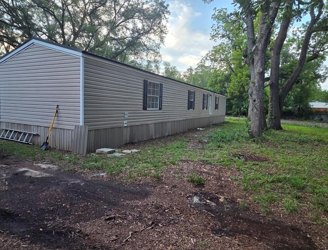 Beautifully updated and move-in ready, this charming 3-bedroom, 2-bath manufactured home in Suwannee County, Florida offers comfort, functionality, and major recent improvements throughout. Situated on approximately 0.52 acres of privately owned land — no lot rent — this well-maintained property combines peaceful country-style living with convenient access to shopping, restaurants, medical facilities, and everyday conveniences nearby, including the Live Oak area just about a mile away.
Featuring approximately 1,125 square feet of living space, this 2007 single-wide manufactured home has been thoughtfully improved with numerous updates already completed for the next owner. Recent improvements include a new septic system and drain field, new water heater, updated electrical outlets and switches, new kitchen backsplash, refreshed countertops, repainted cabinets, trim, doors, and interior walls. The bathroom has also been updated with FRP panels and fresh sealing for added durability and style.
Additional upgrades include new faucets, new ceiling fans, tree trimming, improved roadside drainage completed by the county, and reinstalled/secured skirting around the home. The property also features a durable metal roof, central electric heating and air conditioning, private well and septic, paved road access, and high-speed internet availability through Xfinity and Windstream.
Enjoy outdoor living with a spacious yard, shed/storage/workshop space, and a 22-foot above-ground pool perfect for relaxing or entertaining family and friends. All appliances convey with the sale, making this property even more move-in ready. Best of all, there is no listed monthly HOA fee.
Located just outside the busier city atmosphere while still close to local conveniences, this property offers the perfect balance of privacy, comfort, and accessibility. Whether you are searching for a primary residence, seasonal getaway, or investment opportunity, this lovingly maintained home is a must-see.