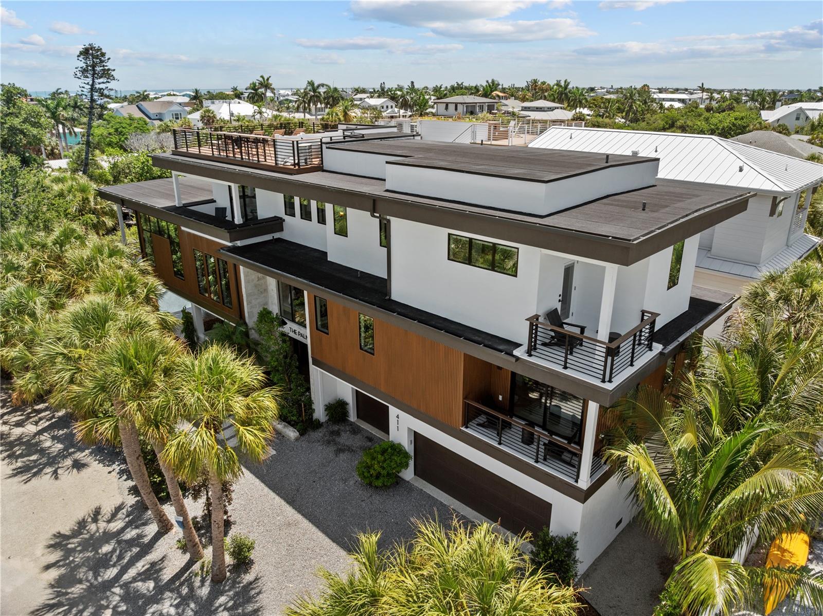 Introducing The Palm—an iconic waterfront estate where exceptional architecture, resort-inspired living, and the unmistakable charm of Anna Maria Island come together to create a remarkable home. More than a home, The Palm captures the very best of Anna Maria Island living. Thoughtfully custom built by Eason Builder Group, this newly completed waterfront residence features five bedrooms, five full baths, one half bath, and more than 3,260 square feet of beautifully designed living space where coastal elegance meets exceptional craftsmanship. Every room has been thoughtfully curated to create an effortless connection between sophisticated design and the natural beauty that surrounds it. Walls of impact glass fill the home with natural light, while tongue-and-groove cypress ceilings, custom millwork, natural stone, and carefully selected finishes create a home that feels refined and welcoming. The open floor plan was designed for effortless entertaining and everyday living, featuring spacious gathering areas, luxurious private suites, a custom bunk room, and seamless transitions between indoor and outdoor spaces. Integrated smart home technology, an elevator, premium impact-rated windows and doors, Daikin HVAC systems, tankless water heaters, composite decking, and quality craftsmanship throughout reflect the care and attention that went into every detail. Outside, the experience is every bit as impressive. A resort-style pool with a raised spa anchors the backyard, surrounded by tropical landscaping that creates beauty and privacy. The covered lanai offers multiple spaces to gather, including an outdoor kitchen, bar seating, comfortable lounge areas, and dining space designed for entertaining family and friends. A private putting green adds another element of fun. One of the home’s most memorable features is the expansive rooftop deck, designed for sunset cocktails and panoramic views stretching across Anna Maria Island.  For boating enthusiasts, The Palm offers one of the island’s most desirable features—a private dock with a 16,000-pound boat lift and direct, no-bridge access to the Gulf, allowing you to leave your backyard and be on open water within minutes. Beyond the property itself lies the lifestyle that makes Anna Maria Island so special. Leave the car behind and explore the island by golf cart or bicycle. Spend your mornings browsing the boutiques, cafés, and local shops along charming Pine Avenue, your afternoons on the island’s world-famous sugar-white beaches, and your evenings enjoying waterfront dining before watching another unforgettable Gulf sunset. Here, life moves at a different pace—one defined by boating, fishing, paddleboarding, beach walks, and the timeless character that continues to make Anna Maria Island one of the Gulf Coast’s most treasured destinations. Whether you’re searching for a private waterfront retreat, a seasonal residence, or a high-end vacation rental with exceptional income potential, The Palm offers a rare opportunity to enjoy the very best of island living while owning one of Anna Maria Island’s premier waterfront homes. Beautifully designed, expertly built, and perfectly positioned, The Palm is more than a residence—it is a place where family and friends gather, memories are made, and the best of Anna Maria Island becomes part of everyday life.