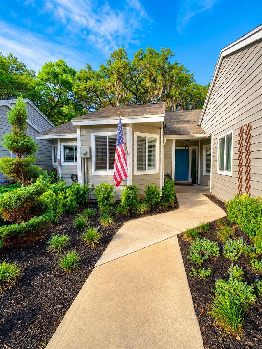 Welcome home to this charming 2-bedroom, 2-bath villa located in the heart of Jonesville area. Nestled beneath mature oak trees in The Villas of West End, this beautifully maintained home offers peaceful views of walking trails at the West End Community park while being just minutes from Tioga Town Center, Publix, restaurants, fitness studios, and I-75. Tucked away on a quiet cul-de-sac, the setting feels private and serene while still close to everything Gainesville has to offer. Inside, vaulted ceilings and natural light create an open, airy feel. The kitchen features granite countertops, stainless appliances, and custom pendant lights imported from the French Riviera, adding a unique touch to the heart of the home. Thoughtfully designed with warm California-inspired style and subtle European influences, the spaces feel both elevated and comfortable. The Florida Sunroom and patio extend the living space outdoors, overlooking peaceful greenery- perfect for morning coffee or relaxed evenings at home. Newly installed oversized Coastal Mist tile adds fresh feel inspired by the tones of the California shoreline, while fresh landscaping enhances the home's curb appeal and welcoming atmosphere. Additional updates include a 2018 roof and new water heater, offering peace of mind for future owners. Residents enjoy access to community amenities including a pool, clubhouse, and tennis courts. Move-in ready and full of charm, this home offers an easy, low-maintenance lifestyle in one of the area's most desirable locations. Contact listing agent today to schedule your private showing and experience the peaceful lifestyle this hidden gem has to offer. This information is deemed reliable but is not guaranteed.