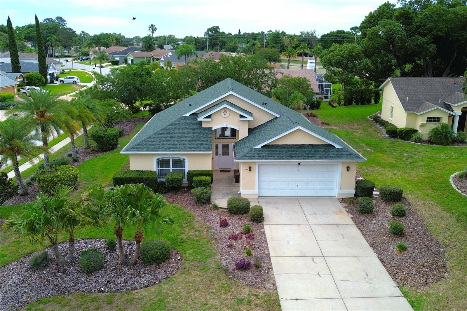 Welcome to this beautiful corner-lot home situated on an impressive 15,332 sq. ft. lot, offering exceptional outdoor space, privacy, and comfort. This well-maintained residence features 1,643 sq. ft. of living area and a spacious 506 sq. ft. two-car garage.  Inside, you'll find 3 generously sized bedrooms, each with its own closet, and 2 full bathrooms featuring elegant glass-enclosed showers. The inviting living room creates the perfect gathering space, complete with an electric fireplace and a wall-mounted TV, adding warmth and style to the home.One of the home's standout features is its high ceilings in select areas, which enhance the sense of openness and allow for an abundance of natural light, creating bright and welcoming living spaces throughout.The expansive front and backyard provide endless possibilities for outdoor enjoyment, entertaining, or parking multiple vehicles with ease. Additional highlights include a roof that is only 3 years old, offering peace of mind for years to come.Residents of this sought-after community enjoy outstanding amenities, including a clubhouse, resort-style swimming pool, tennis courts, and pickleball courts. The HOA fee includes high-speed internet service and lawn maintenance, allowing for a more convenient and carefree lifestyle.  Don't miss this exceptional opportunity to own a spacious corner-lot property that perfectly blends comfort, functionality, and desirable community amenities. Schedule your private showing today and discover all this wonderful home.