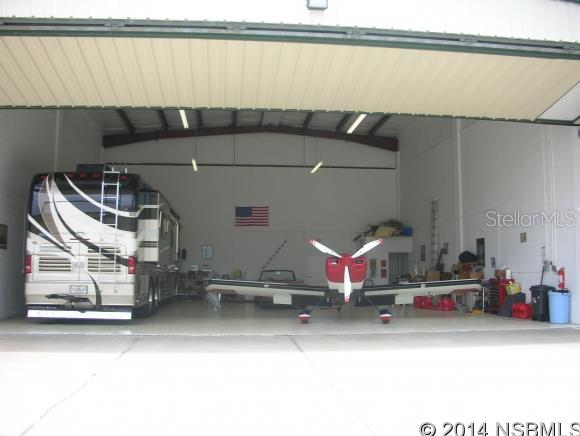 Located in the Commercial Area of Spruce Creek Fly-in, America's Premier Fly-In Gated Country Club Community with 24/7 security, 4000' paved runway w/GPS approach & VASI lights, this hangar measures 45x50 with a 44x17' insulated bi-fold electric hangar door. Half bath. Plenty of room to build second floor office. (The Spruce Creek Fly-In Community offers 24-hour manned and gated security, the Downwind Cafe Restaurant is on the field, several locations for obtaining both 100LL or Jet fuel, residential condos as well as single family homes from $150,000 to $2mil+, as well as  membership opportunities at the Spruce Creek Country Club.) Owner Financing Available to Qualified Buyer. 2014 Tailwinds Condo fees of $426 per quarter & $1350 for Spruce Creek Property Owners Assn include 24-hour security, maintenance of airport, taxiways, streets parks & common areas. Close to restaurants, shopping & medical facilities, World's Most Famous (Daytona) Beach, Embry Riddle Aeronautical Univ & 1 hour to Orlando. All measurements deemed reliable but not guaranteed. (Partner/Owner is licensed real estate broker). ;Water: Available at Site ;Water: City