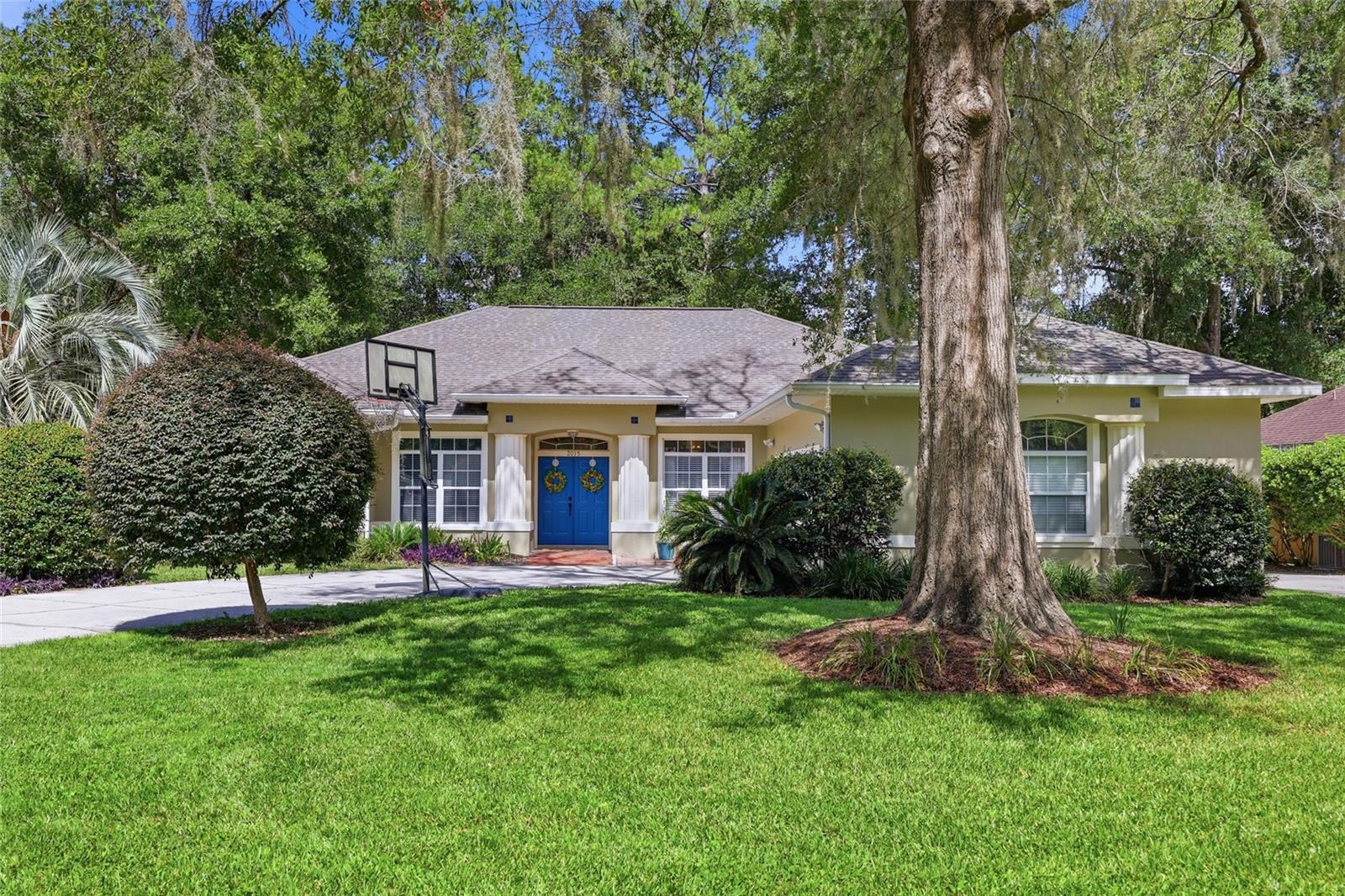 Welcome home to this spacious and thoughtfully designed residence tucked away on a quiet cul-de-sac in one of Northwest Gainesville's most established neighborhoods. A stately covered entry with classic columns and vibrant double front doors create a warm first impression as you step inside. The foyer opens to an inviting formal living room with soaring ceilings while the formal dining room offers the perfect space for entertaining family and friends. Beyond, the heart of the home features an expansive kitchen with abundant cabinetry, granite countertops, stainless steel appliances, a center island, pantry, breakfast bar, and sunny breakfast nook, all flowing seamlessly into the family room where a fireplace and custom built-ins create a comfortable gathering space. Privately located on one side of the home, the primary suite serves as a peaceful retreat with tray ceilings, two walk-in closets, and an ensuite bath featuring dual vanities, a soaking tub, separate walk-in shower, and private water closet. Just off the primary suite is an additional bedroom offering the perfect space for guests, a nursery, or a home office. The opposite wing of the home features two additional bedrooms connected by a shared bathroom with a single vanity and a separate tub and toilet room, providing added functionality for busy households. One of these bedrooms is currently without a closet, though one could easily be added to restore it as a traditional bedroom. A third full bathroom is conveniently positioned with direct access from the primary hallway and Florida room, making it ideal for guests and perfectly suited for future outdoor entertaining or a pool. Stretching across the back of the home, the oversized Florida room dramatically expands the living space and offers endless possibilities as a game room, media room, fitness area, or second family room. As an added bonus, a separate finished room located off the Florida room provides incredible flexibility and can easily serve as a fifth bedroom, private office, hobby room, or additional guest suite. The generous screened porch extends the living space outdoors, providing a comfortable setting for dining, relaxing, and enjoying Florida's year-round weather. The spacious fenced backyard shaded by mature trees, offering plenty of room for pets, play, gardening, or simply enjoying the peaceful setting. For added peace of mind, the seller will replace the roof with an acceptable offer, providing significant value for the next owner. Additional features include an indoor laundry room, side-entry garage, abundant storage, and mature landscaping. Ideally located near Santa Fe College, North Florida Regional Medical Center, the University of Florida, I-75, shopping, dining, and parks, this home is also zoned for Hidden Oak Elementary, Fort Clarke Middle School, and Buchholz High School. Offering a flexible floor plan, generous living spaces, and an exceptional Northwest Gainesville location, this home is ready to welcome its next owner.