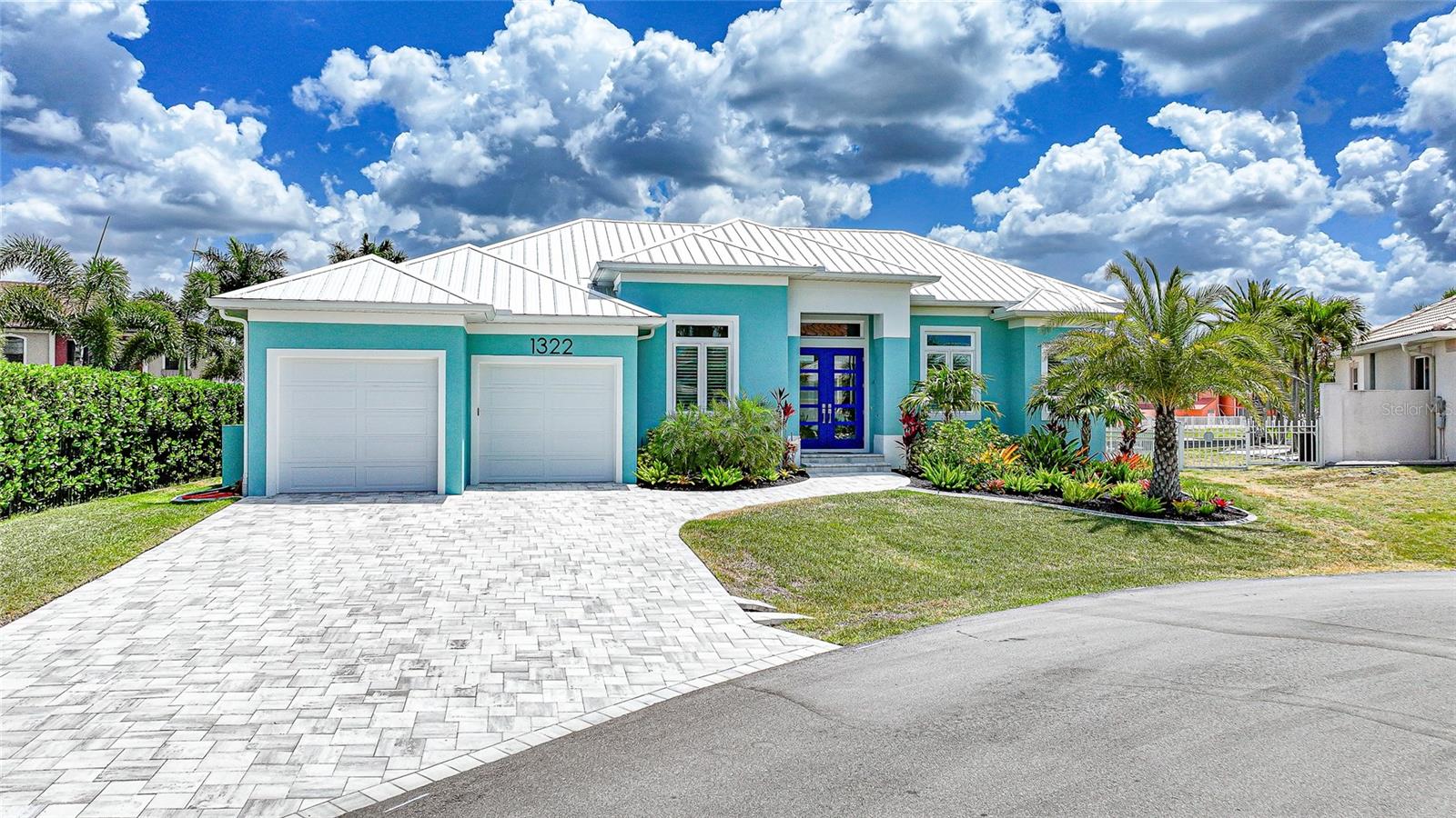 Custom built by West Coast Builders’ Sean Howard, this exceptional residence delivers a rare combination of architectural quality, elevated construction standards, & refined coastal luxury—set on 105 feet of prime waterfront with premier boating access. Offered mostly furnished, this home is truly move-in ready & designed for effortless, upscale Florida living. Inside, you’ll find a bright, open floor plan with high soaring ceilings & a stunning living room with a double tray ceiling & ambient rope lighting. Plank tile flooring runs throughout the entire home, complemented by upgraded lighting, recessed interior & exterior soffit lighting, and a full AV pre-wire. The gourmet kitchen is both stylish & functional, with Bosch stainless steel appliances, an induction range, custom vent hood, under-cabinet lighting, tile backsplash, spacious walk-in pantry with custom wood shelving, & Cambria quartz countertops. The adjacent dining area provides beautiful views of the lanai and waterfront. The primary suite is a luxurious retreat with private lanai access, dual vanities with quartz countertops, a walk-in shower with custom tile & glass enclosure, & a fully customized walk-in closet with wood shelving. A private guest suite also offers lanai access & an en suite bath, plus there is a third bedroom. All bathrooms include custom tile showers with niches & glass enclosures. Built with quality in mind, the home has concrete block construction, engineered trusses, batt insulation, impact-resistant windows & doors, hurricane protection, along with a 10’6” elevation. Step outside to your resort-style outdoor living space, where a heated, saltwater pool by Fulton Pools takes center stage. Designed for both relaxation and entertaining, it features: Pebble Tec finish with lifetime warranty, LED lighting, swim-out bench, plus a panoramic super screen enclosure. The expansive paver lanai also includes a fully equipped custom outdoor kitchen with a 32” Summerset grill (rotisserie), Zephyr vent hood, outdoor refrigerator, granite countertops & backsplash, sink, and built-in storage—perfect for entertaining year-round. For boating enthusiasts, the property boasts an extended 10’ x 45’ dock, complete with a 9,000 lb boat lift, aluminum walk board, and quick access to open water, with just one bridge. Additional highlights include: 2-car garage with polyaspartic-coated floors, custom shelving, electric vehicle charging setup and generator hookup with transfer switch, laundry room with LG washer/dryer, sink, and cabinetry, 50-gallon hybrid water heater with recirculating pump, security system wiring, custom landscaping with concrete curbing and irrigation system, hidden outdoor trash area, full exterior soffit lighting and upgraded finishes throughout. This is a true builder-quality home, combining structural integrity, high-end finishes, and a thoughtfully designed outdoor lifestyle—all in one of Punta Gorda Isles’ most desirable waterfront locations.