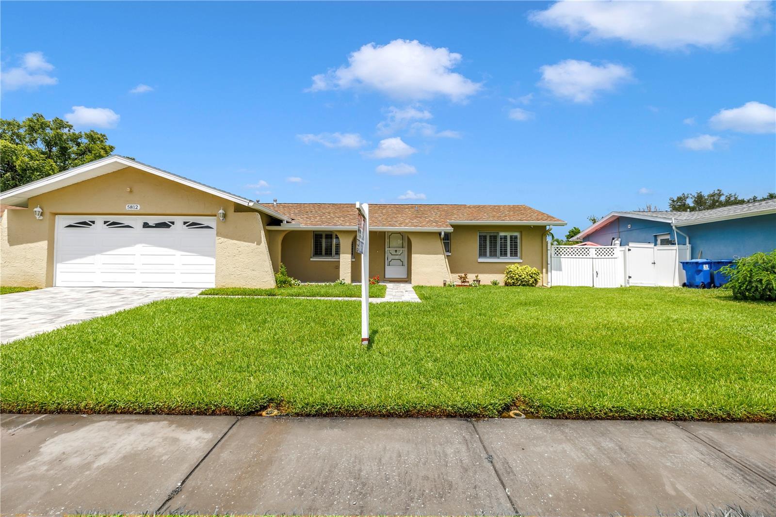 Welcome to Paradise says this charming ranch home in the Twin Lakes Subdivision. This charmer is located by Shore Acres School & Mangrove Golf course. This updated 3 bed 2 bath 2 car garage features a brand new roof. It also has granite counters, solid wood cabinets, stainless appliances and updated bathrooms. There is a walk out side garage door leading to a large fenced yard overlooking common ground. The exterior and interior has been recently painted throughout. The home also features brand new pavered driveway and sidewalk leading to the front porch. The home is light, bright and neutral ready for new buyers. Off the large living room and kitchen leads to the Florida Room 28x11 perfect for entertaining. Great subdivision, great location to schools and shopping and it DID NOT FLOOD! Welcome to paradise with this lovely ranch home!
