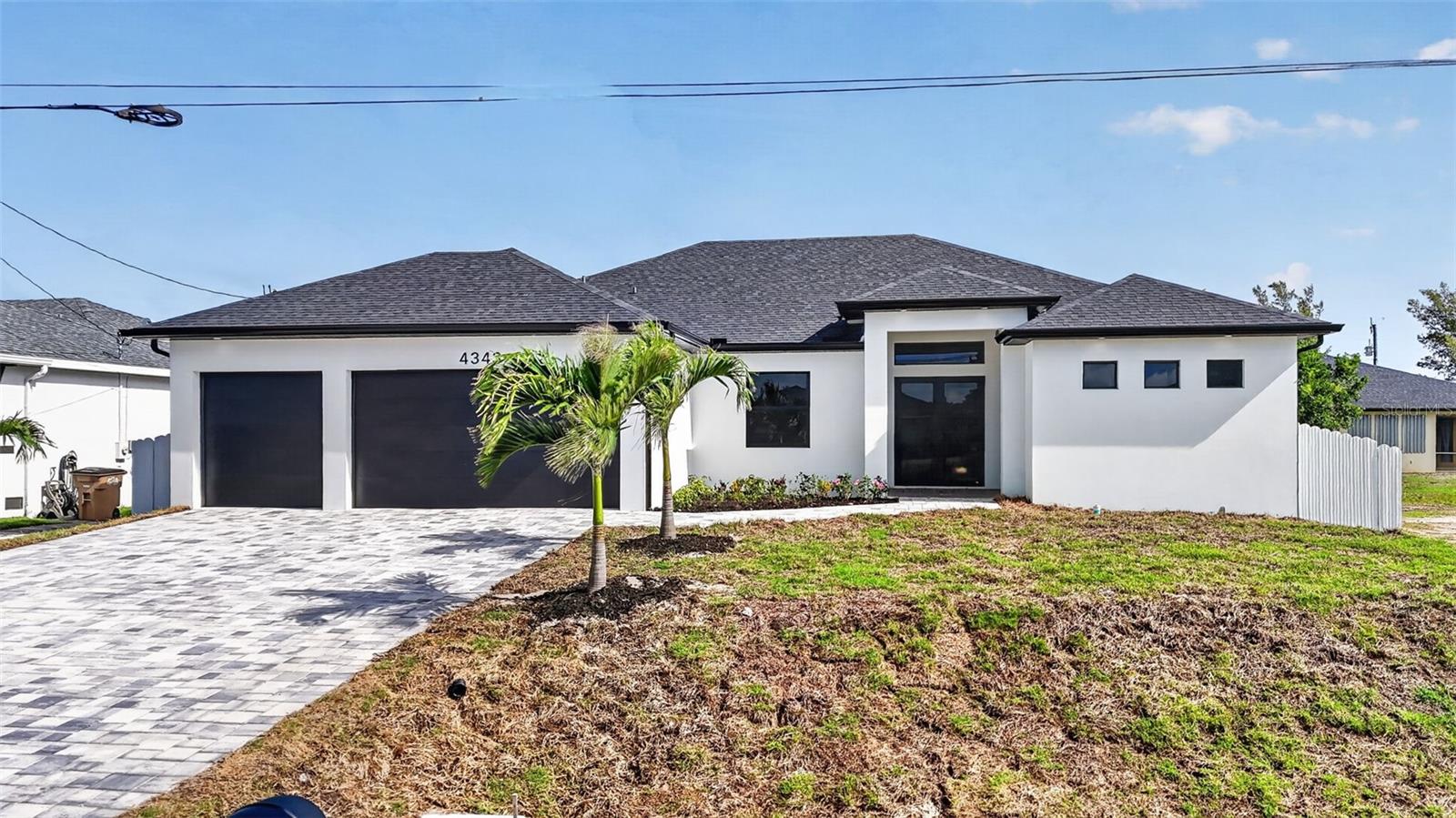 PRICE REDUCTION! This stunning new construction residence offers the perfect blend of modern design and Florida lifestyle living. Situated on a high-elevation lot for added peace of mind this home features 3 bedrooms + den, a 3-car garage, a fully fenced backyard and a paver-lined driveway framed by lush palms. Step inside and experience a bright, airy atmosphere enhanced by sparkling porcelain tile throughout, tray ceilings, and an open-concept layout designed for both everyday living and entertaining. The showpiece kitchen delivers a true “wow” factor with sleek European-style cabinetry, pristine white quartz countertops, and a dramatic waterfall island overlooking the main living area and pool. The outdoor space is a true Florida retreat—featuring a beautifully designed pool, expansive paver deck, generous covered lanai with contemporary fans, and ample room to create your dream outdoor kitchen. Additional upgrades include impact windows and doors, custom California-style closet systems, tankless water heater, and an epoxy-coated garage floor. Located just minutes from Crystal Lake Park, the vibrant waterfront charm of Matlacha, the laid-back island lifestyle of Pine Island, and the highly anticipated Seven Islands Project—plus a short drive to the walkable downtown of Punta Gorda—this home places you at the center of Southwest Florida’s most exciting growth corridor. Modern, elevated, and effortlessly stylish—this is Northwest Cape Coral living at its finest.