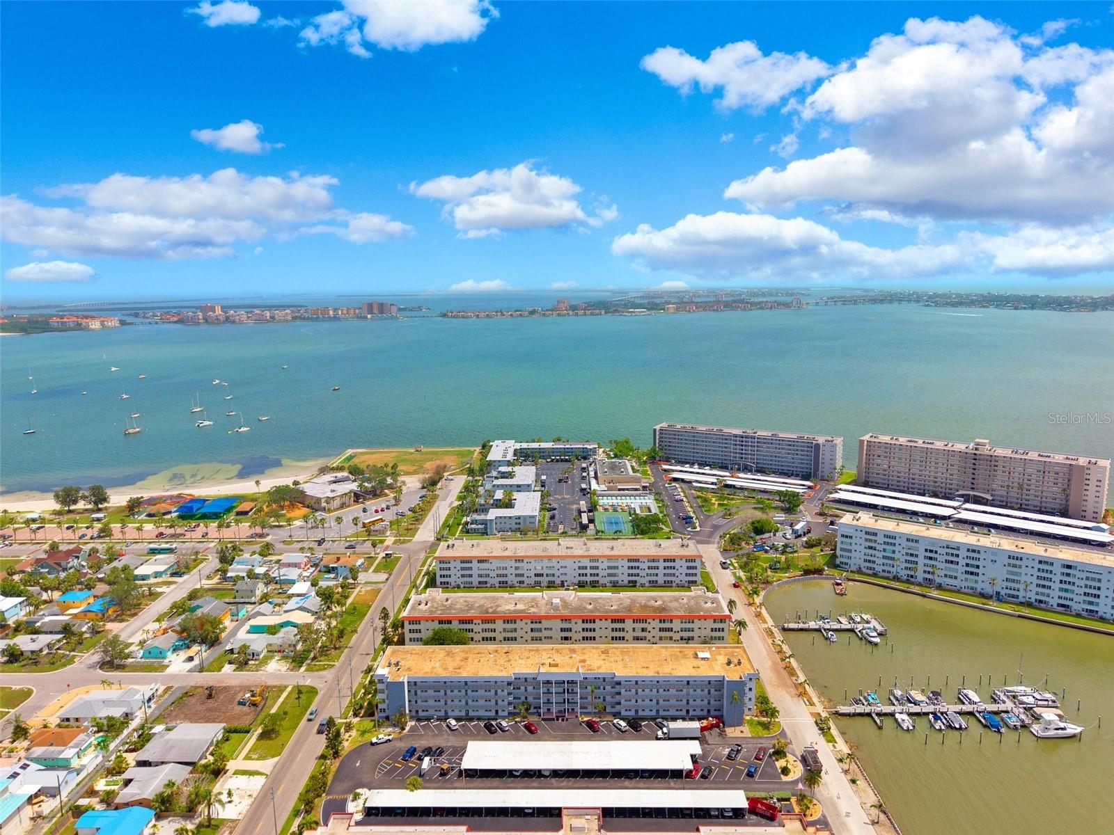 4th floor unit in Town Shores with elevation, natural light, and the kind of breeze you only get this close to the water. Clean layout, easy flow, and a space that feels right the second you walk in.
This isn’t about just buying a condo — it’s about getting into one of Gulfport’s most active waterfront communities.
Town Shores sits directly on Boca Ciega Bay and delivers a true resort-style setup with multiple heated pools, private marina access, and waterfront walking paths.
You’ve got tennis, pickleball, shuffleboard, bocce, a full clubhouse, fitness center, and a calendar of events that keeps the community active year-round.
Kayak storage and launch, boat slips (when available), and open water access put you right in the middle of everything coastal buyers are looking for.
One of the most walkable 55+ communities you will find — minutes to downtown Gulfport, the waterfront district, local restaurants, and a straight shot to St Pete Beach and Pass-a-Grille.
If you’re comparing units in Town Shores, this one checks the boxes that matter: higher floor, better airflow, solid positioning within a community people move to for the lifestyle.
Now to get to the actual unit, fully updated from head to toe. Yes, that includes the popcorn ceiling being removed, saving you thousands of dollars. All new cabinets, countertops in the kitchen and entertaining island, plus new flooring throughout. A great safety perk is a new whole building fire alarm has just been installed and fully paid for already.  Now to get to something that a contractor or Home Depot can’t give you…Your pets are welcome! This is one of only 3 buildings in Town Shores that allows pets.  This partially furnished unit just needs one thing, for you to unpack your bags, walk out the door and smile as you look out over the water.