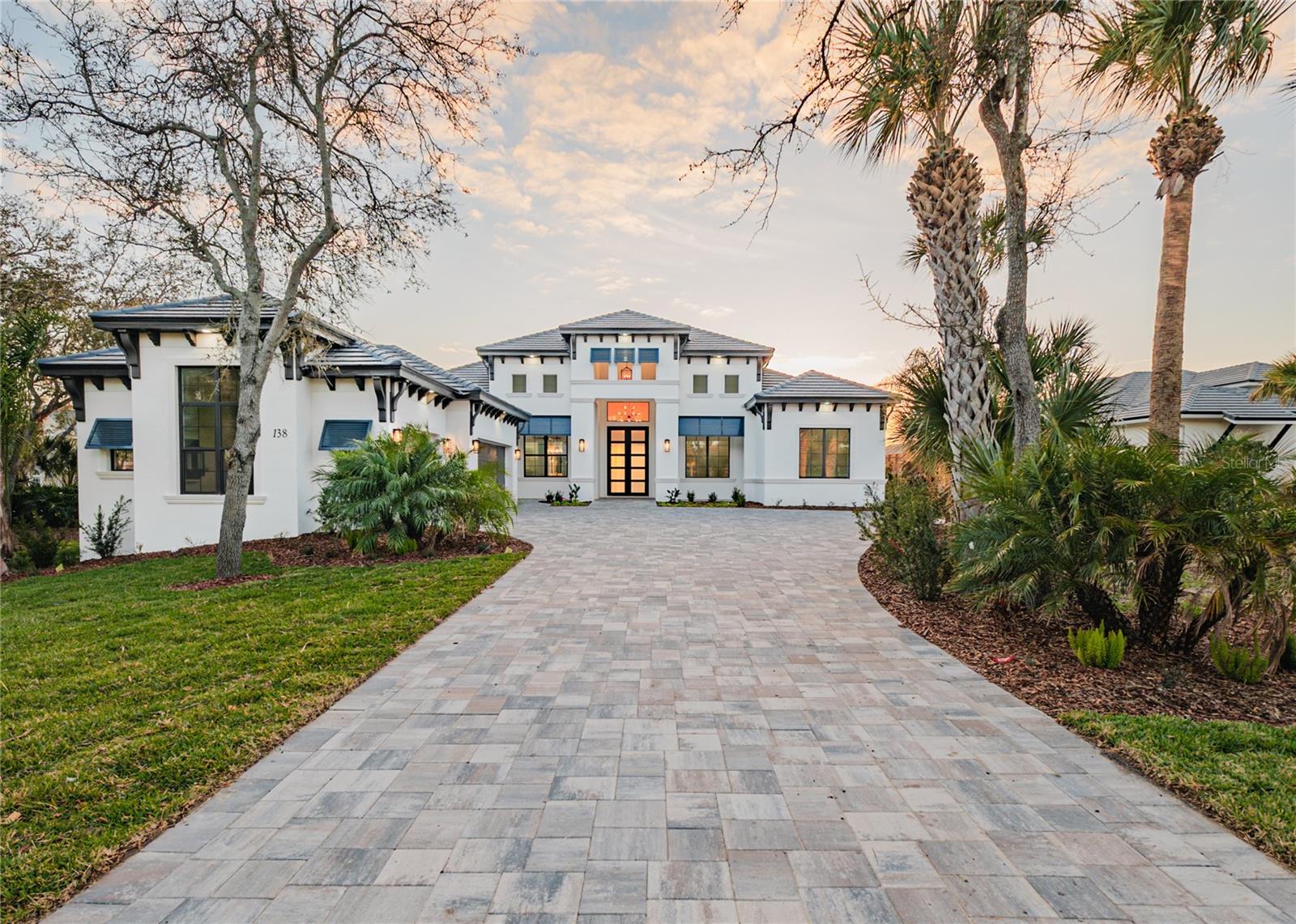 Welcome to the private Community of Island Estates! Custom crafted and just completed by the esteemed artisans at Skyway Builders, this exquisite pool home epitomizes luxury, offering a harmonious blend of privacy, refinement, and nature. Upon entering, the meticulous design and impeccably crafted residence, your senses will be instantly captivated with an abundance of natural light and views of the intracoastal waterway. The home boasts three bedrooms, a private exterior entry study or a 4th bedroom, a library, an exercise room, and four full bathrooms, each element is curated to evoke unparalleled comfort and functionality. The dedicated exercise room promotes physical vitality, While the library and office allow for a private workflow, ensuring every aspect of your lifestyle is nurtured within the confines of your home. The heart of the home unfolds in the form of a gourmet kitchen, butler’s pantry, and wet bar replete with top-of-the-line appliances and custom cabinetry, seamlessly flowing into the outdoor sanctuary. Open the large custom sliding glass doors to the covered lanai, creating a seamless transition between the exterior living space and the outdoor kitchen, pool, and yard for enhanced entertaining. Outside enjoy the comfort of a gas fireplace and exterior living room, where an alfresco kitchen beckons amidst the backdrop of a mesmerizing pool overlooking the serene expanse of the Intracoastal. Here, culinary indulgence merges effortlessly with the tranquility of nature, creating an enchanting ambiance that is as invigorating as it is captivating. Retreat to the luxurious master suite—a sanctuary of serenity and elegance—boasting dual walk-in closets and a spa-like master bath adorned with lavish fixtures and a sumptuous tub, offering a respite from the demands of daily life. With the owner's unwavering commitment to unparalleled craftsmanship and innovation, every facet of this home exudes exclusivity and refinement, catering to the most discerning buyer. Embrace the pinnacle of luxury living in Island Estates at Hammock Dunes—a sanctuary where every amenity and detail ensures a lifestyle of comfort, relaxation, and well-being, truly embodying the essence of elevated living. Schedule your exclusive viewing today and step into the extraordinary world of luxury living that awaits you in Island Estates at Hammock Dunes! Room Feature: Linen Closet In Bath (Primary Bathroom).