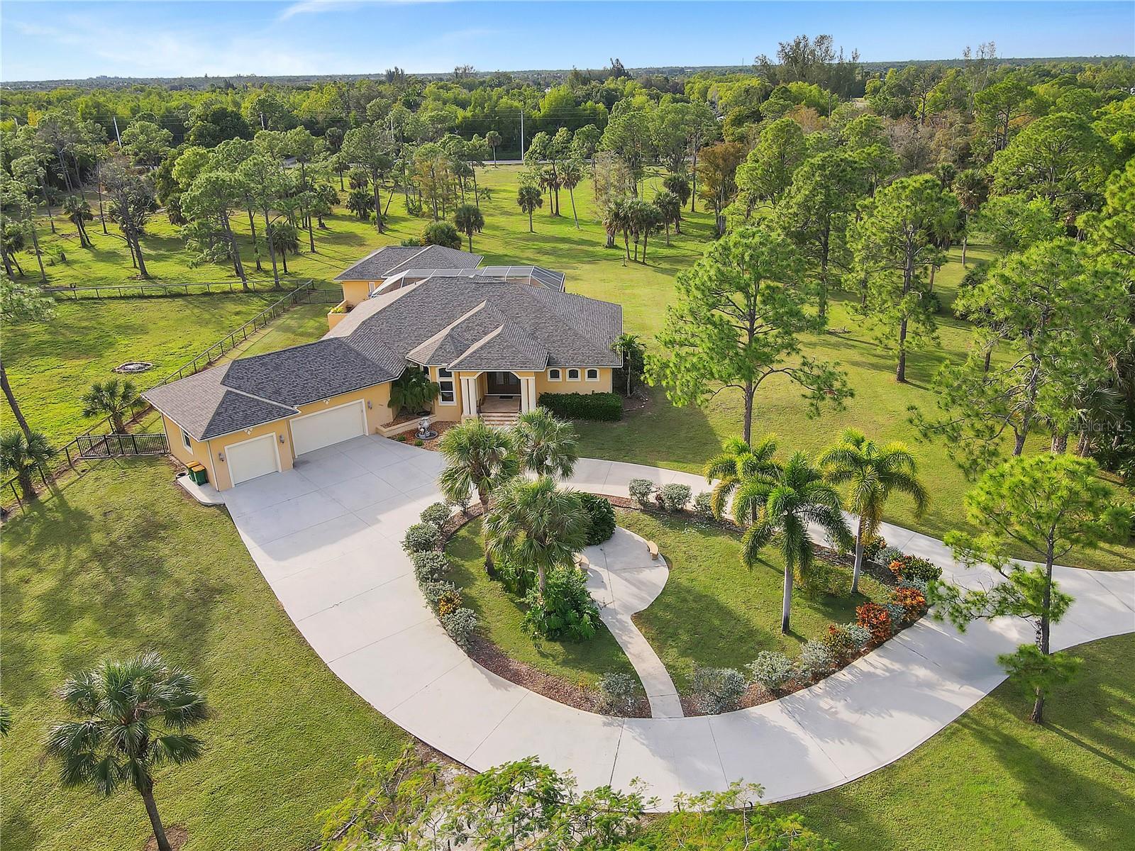 The perfect place to start your Naples, Florida homestead! Situated on 14+ acres of uplands, the sprawling custom-built home, guest house and horse barn feels like a private oasis while located only 15 minutes to Marco Island and Downtown Naples. Enjoy your solitude and rest easy knowing your home is built like a fortress - offering concrete block walls, structural concrete beams, impact windows, and a brand new roof in 2019. Inside has all the modern luxuries of a custom-built home with soaring tray ceilings, 8’ solid wood doors and trim, and pocketed impact windows that integrates your sprawling lanai and gorgeous pool and spa. The private 1/1 guest house overlooking the pool offers a full kitchen and private sun deck. For the Equestrian enthusiasts, the 2859 sq ft barn and stable is among the best in Collier County. Surrounded by pastures the barn includes 4 custom stalls, feed room, tack room, an extra deep 2 car garage, and a large covered run-in area that can easily be made into 2 additional stalls. The possibilities are endless.