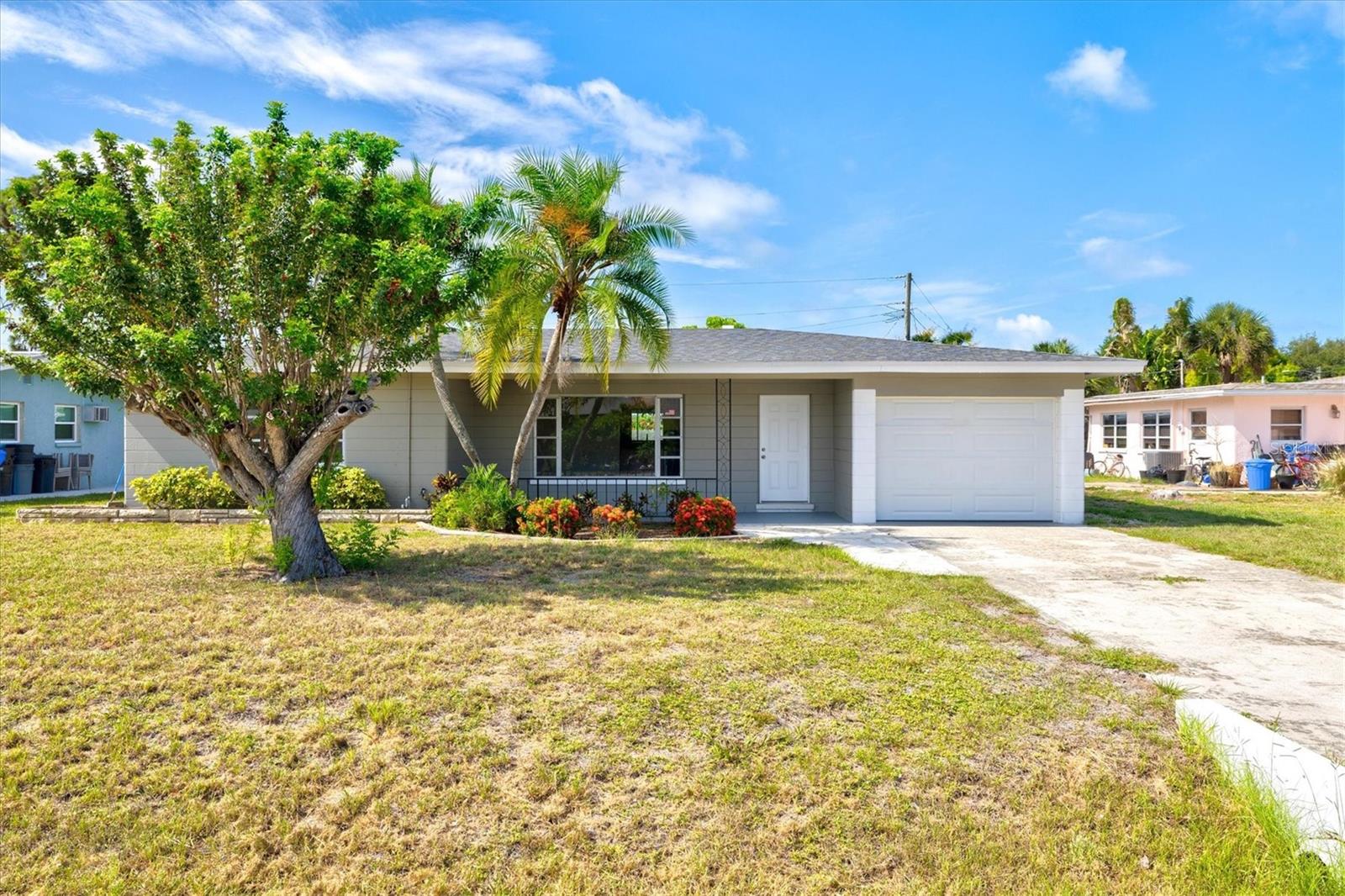 Virtually Staged. The wait is over - this VENICE ISLAND 3/3 Remodeled Gem is the one you've been waiting for! This rare beauty has 3 bedrooms, 3 FULL remodeled BATHS, and OVER 1900 SQFT of living area! With TWO primary suites and an extra guest bedroom/guest bath, this is the ideal family home, winter retreat, or investment seasonal rental property! Fully remodeled, this home has a wide open floor plan. A brand new kitchen with white cabinets, beautifully tiled backsplash and large island is truly the heart of the home - with multiple spacious living areas all around it. A living room up front, a family room in back, and a dining room in between make this floor plan perfect for entertaining with space for all your friends and family. That's not all - take the party outdoors with your huge SCREENED-IN LANAI in the rear of the home. Extend your living area here even further, with plenty of room for an outdoor living area with TV, al fresco dining for barbecues and parties year round, or BOTH. You'll find storage cabinets out here for seasonal decor, outdoor games, or whatever else you need to store! Back inside, the storage continues - which is rare for an island home, with TWO CLOSETS for each bedroom, a walk in closet plus linen closet in the primary, and two hall linen closets in the guest room wing. The two en suite bathrooms each contain brand new CUSTOM TILED SHOWERS, dual sinks with QUARTZ counter in the primary bath, and a tub/shower custom tiled surround in the third guest bath.  OTHER FEATURES: BRAND NEW GARAGE with peg board wall storage, SPLIT bedroom floor plan, ROOF 2025, newer AC, NEW impact sliders and NEW windows to be installed for the new owner! Beach Manor is just blocks from the beach at Maxine Barrett Park, Sharkey's Pier, and one mile from the infamous Downtown Venice and Venice Ave. This is walkable to restaurants, bars, shopping, the library, splash pad, museums, or literally only a few minutes' ride on a bike, scooter or golf cart! Come live the Venice Island dream with the perfect location - can't get much closer to beaches, schools, Lake Venice Golf, and MORE - for way less than homes in this condition are going for! Schedule your private showing today.
