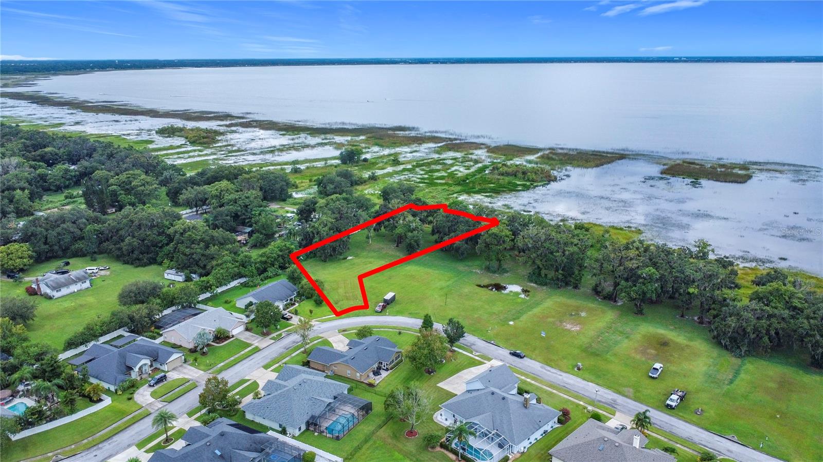Welcome to your slice of waterfront paradise. Tucked inside the upscale, gated community of East Lake Reserve, this oversized lot spans over 1 acre, features a potential long private, discreet entry that broadens into an expansive lakeside sanctuary—providing ample room to design a luxurious custom home perfectly tailored to your lifestyle.
Enjoy direct access to East Lake Tohopekaliga, one of Central Florida’s most scenic and expansive lakes—perfect for boating, kayaking, fishing, or simply relaxing along the shoreline. Imagine waking to breathtaking sunrises over glassy waters and ending your day with golden sunsets from your future dock or backyard retreat.
Beyond its natural beauty, this location offers unmatched convenience—just minutes to vibrant Lake Nona dining, shopping, and top-tier medical facilities, as well as Orlando International Airport. Major highways, including 417, 528, and Florida’s Turnpike, are all within easy reach.
Under the shade of towering oaks, envision your private lakeside haven—complete with a pool, expansive patio, and custom dock. This is more than just a lot; it’s the starting point for your forever home on the water.