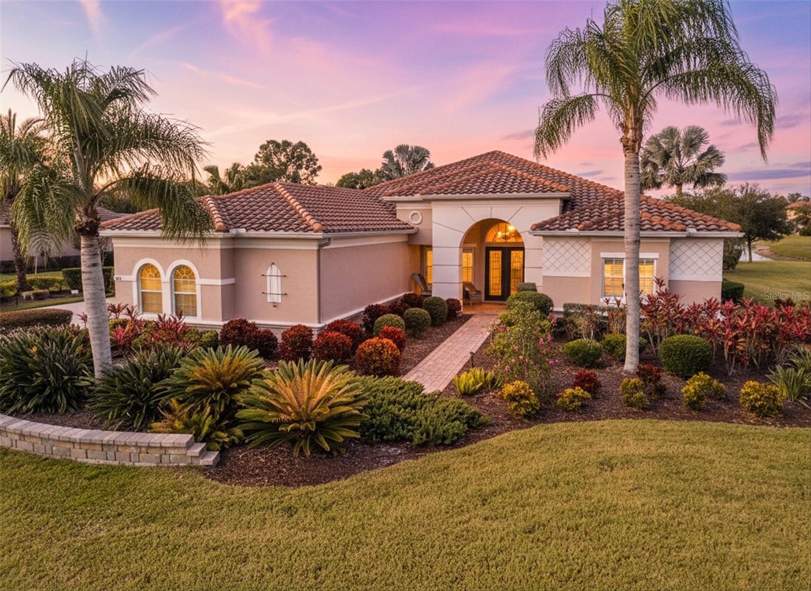 True Florida living with style, space, and serene views. Perfectly positioned on an expansive 0.53-acre lot overlooking a peaceful pond and preserve, this stunning estate home is located in the highly sought-after Rye Wilderness Estates community. Spanish-style architecture and a charming arched front porch create an inviting first impression, while thoughtful upgrades and timeless design continue throughout this spacious 3,451-square-foot Egret model.

This four-bedroom, three-bathroom home with a dedicated office features a tile roof, paver driveway, and a three-car side-entry garage, along with newly updated pool equipment and two brand-new AC systems for added peace of mind. Upon entering through double eight-foot front doors, you are welcomed by a grand foyer with soaring twelve-foot ceilings, ten-foot ceilings throughout the rest of the home, and elegant tray ceiling accents. To the left, a formal dining area flows seamlessly into an oversized living room, where sliding glass doors frame tranquil lanai, pond, and preserve views.

The living room connects to a beautifully designed butler’s pantry and wet bar with long counters, sink, and a striking tile feature wall, making it ideal for entertaining. Continuing into the heart of the home, the gourmet kitchen impresses with a large center island, gorgeous granite countertops, breakfast bar seating, solid wood cabinetry with pull-outs, under-cabinet lighting, and a vented decorator hood. The kitchen opens to a spacious family room with additional sliding doors leading to the outdoor living area.

The split floorplan offers privacy, with the second and third bedrooms sharing a full interior bathroom, while the office is conveniently located just off the front entry. The expansive primary suite is a true retreat, featuring tray ceilings, private lanai access, a large California-style walk-in closet plus additional open storage, and a spa-inspired en-suite bathroom with dual vanities, a makeup area, garden tub, and an oversized walk-in shower. A spacious laundry room with extra wood cabinetry adds both function and storage.

Step outside to an impressive covered lanai overlooking the heated pool and paver deck, creating the perfect outdoor oasis for enjoying Florida’s year-round sunshine and breathtaking preserve views. Located just north of Rye Wilderness Preserve, residents can enjoy kayaking and canoeing nearby. The community offers no CDD fees, a low HOA, convenient interstate access, proximity to Lakewood Ranch, top-rated schools, world-famous beaches, Sarasota, St. Petersburg, and Tampa International Airport.