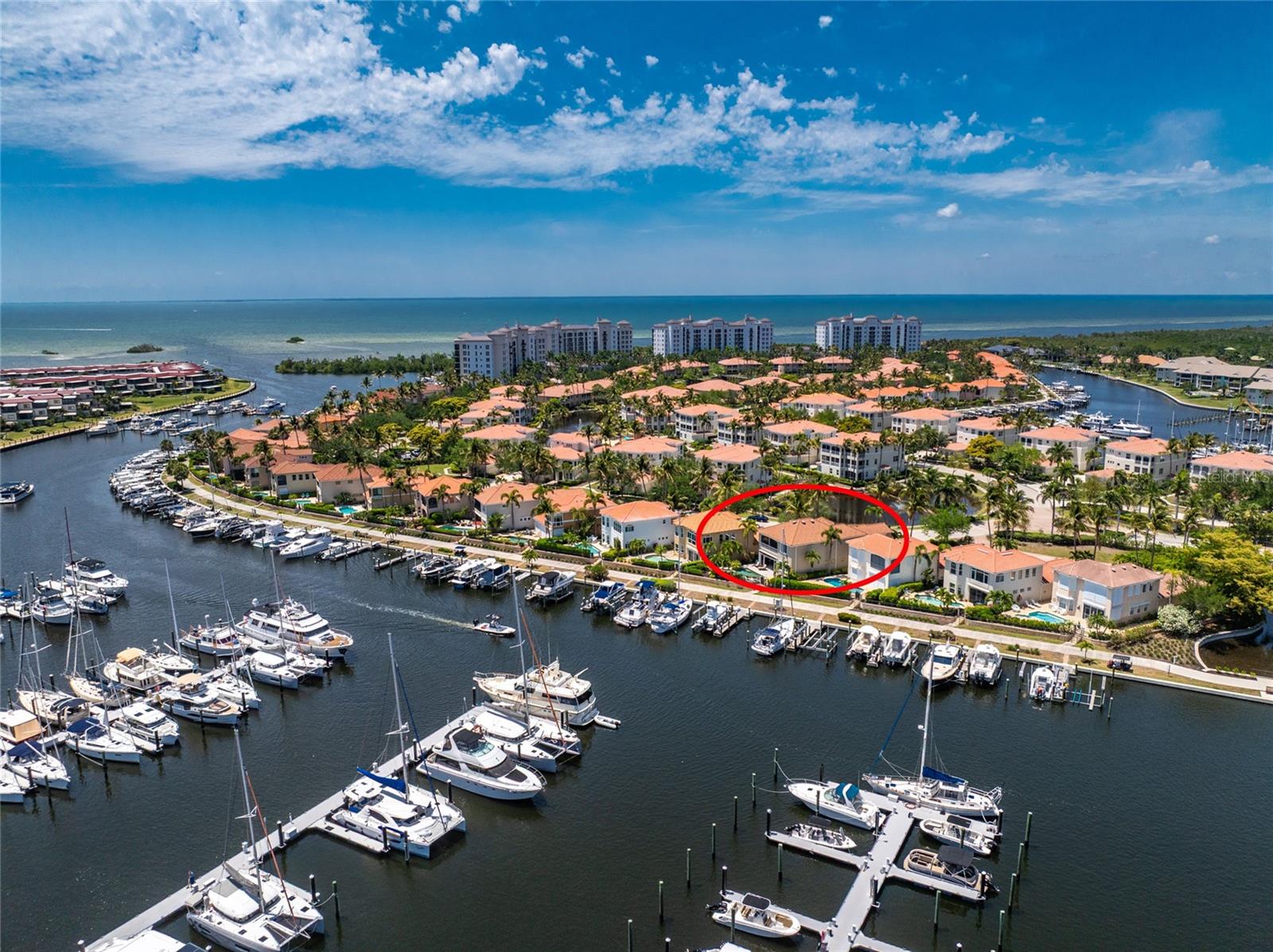 Premier marina-front residence situated on the coveted south basin in Burnt Store Marina is inviting serious boaters to come explore what it has to offer. Located on a desirable gated peninsula, with immediate unobstructed access to Charlotte Harbor and just 10 nautical miles to the Gulf.  This dramatic two story residence has been lovingly updated and maintained for its next owner, and offers a rare transferable slip rental directly behind the home - complete with a 14,000 lb lift (without the two year wait). From spontaneous sunset cruises to effortless days on the Gulf, this setting is designed for true resort on-the-water living. The home was recently painted (2025) with a new metal coated ROOF INSTALLED IN 2024. NEW ANDERSON DOUBLE PANED WINDOWS WERE INSTALLED IN 2024, with a complete shutter system. You will be thrilled when you step inside and experience the grandeur of the soaring two story living space enveloped by abundant windows that capture the beautiful blue skies. Slide open the glass doors leading to the striking outdoor living area featuring a handsome heated salt water pool (with updated equipment) & spa, with updated Pebbletec surface and tasteful waterline tiles.  The multilevel expansive deck provides ample seating/ lounging for you and your gang. True resort living comes alive here where you can soak up the sun from this south facing deck, as you watch the boats & walkers passing by. Extend the brand new retractable awning to provide shade while sipping on your favorite libation at happy hour and toast to a beautiful sunset to commemorate another fabulous day in paradise. Inside the main living space is grounded by attractive tile flooring with a distinctive compass inlay, while plantation shutters and elevated tropical fixtures carry a cohesive, polished aesthetic throughout. The impressive gourmet kitchen is designed for both everyday living and entertaining, featuring abundant raised-panel wood cabinetry with custom pull-outs, decorative corbels, and under-cabinet lighting and dual sinks. Pleasing stone tops and a coordinating backsplash frame a spacious breakfast and gathering bar, complemented by a full suite of newer KitchenAid stainless appliances, including an oversized induction cooktop, double wall ovens, and warming drawer. The adjoining nook is sure to be one of your favorite gathering spots, overlooking the pool & marina with additional cabinetry and a built-in desk. This three bedroom/ four bath home is being offered TURNKEY FURNISHED and also offers a cozy media room with attractive double french doors and electric fireplace for those chilly nights.  The primary suite offers a private sanctuary, complete with a bonus sitting area, dual closets, and a secluded screened lanai overlooking the marina basin. The spa-like bath features custom tilework, a Roman shower, Jacuzzi tub, dual vanities, and a custom cosmetic station.  Comfortable guest accommodations both upstairs and down are thoughtfully designed with private baths. Other updates include a whole-home water filtration system, updated electrical panels, and two 2.5 yr old A/C systems. The 2.5 car garage is equally impressive with epoxy flooring, newer mini-split air conditioning, and accommodates 2 cars and a handsome 2025 GOLF CART that is INCLUDED.