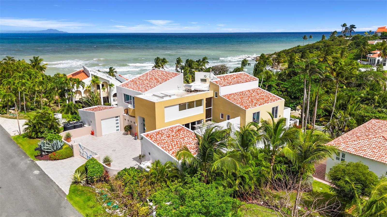Experience exceptional island living with this rare oceanfront estate located in the exclusive Harbour View enclave of Palmas del Mar, Puerto Rico. This secluded and elegant compound sits on two adjacent lots, offering a one-of-a-kind combination of privacy, sophistication, and direct beach access.

Recently renovated with premium finishes throughout, the estate consists of a main residence and a spacious guest house—perfectly designed for luxurious coastal living, multigenerational families, entertaining, or income-generating potential. HOA $1,300/year CRIM/Property Taxes: $5514

Main Residence Highlights:
8,139 SF total (6,452 SF interior + 1,687 SF terraces)
Custom Italian porcelain floors and imported Italian doors
Lutron smart lighting system and Sonos sound throughout
4 bedrooms, 4.5 bathrooms including a stunning private owner’s suite with ocean-view terrace
Chef’s kitchen with Thermador appliances
Expansive living/dining area opening to outdoor terrace
Custom staircase and elevator
Hurricane-resistant windows
60KW generator with 300-gallon diesel tank
(2) 400-gallon water cisterns

Guest House Features:
2,532 SF interior
2 bedrooms, 2.5 bathrooms
Great Room, full kitchen, wine cellar, and storage
Storm shutters

Outdoor Paradise:
Heated saltwater pool and jacuzzi
Outdoor kitchen with BBQ, stove, sink, and dining space
Gazebo, firepit, lush landscaping
Direct access to a secluded beach

Live the Palmas lifestyle with access to golf courses, tennis courts, an equestrian center, pre-k to 12th school, marina, yacht club, and world-class dining—all within 40 minutes of San Juan.

Additional Highlights:
Move-in ready
Seller financing available
Seller accepts cryptocurrency

Motivated seller. This is a once-in-a-lifetime opportunity to own a tropical retreat that blends exquisite design with unmatched natural beauty and amenities.