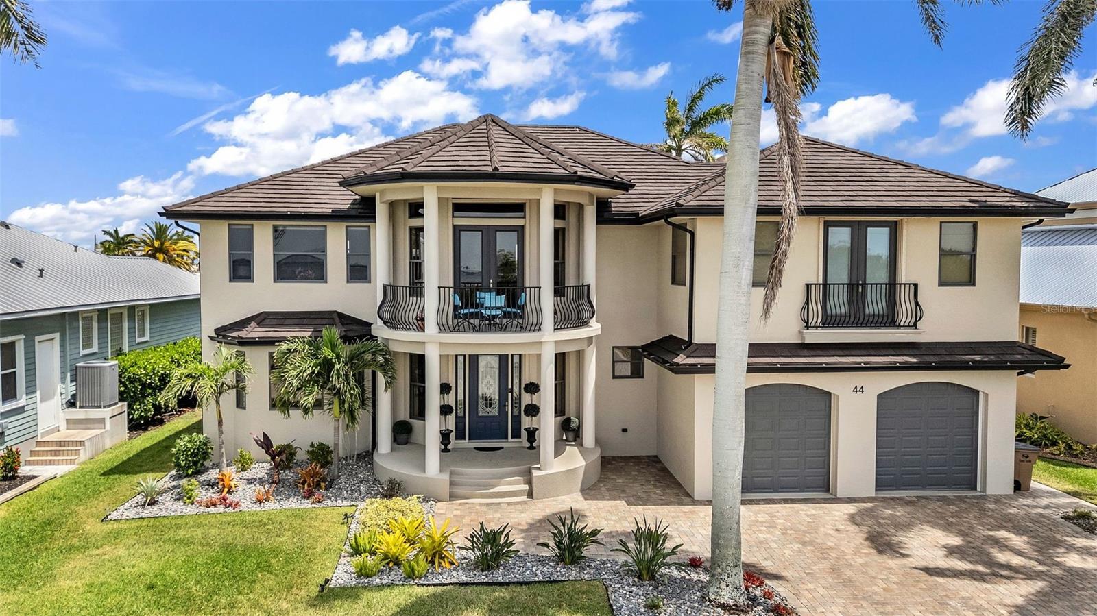 Positioned between a wide canal and the open expanse of the Peace River, this custom residence delivers a RARE DUAL WATER EXPERIENCE, sunrises in the back, sunsets in the front, and sailboat access to Charlotte Harbor just minutes away. Originally built in 1981 and thoughtfully reimagined in 2012, the home blends its classic waterfront roots with a more modern, livable design. Start your mornings on the lanai as boats glide past and dolphins and manatees surface in the canal. Spend your afternoons poolside, surrounded by travertine decking and a heated saltwater pool designed for both relaxation and entertaining. Then, as the day winds down, move to the front patio where sweeping Peace River views provide a nightly sunset show. For boaters, this is what it’s all about: a 60' CONCRETE DOCK WITH A 16,000LB LIFT and quick, unobstructed access to open water. No long idle zones. No compromises. Inside, the home is designed to feel elevated yet livable. Natural light fills the main living spaces, with water views woven throughout. The kitchen is built for real use and gathering, featuring a large center island, custom cabinetry, high-end appliances, a wet bar, a beverage center, a pot filler, and a unique prep area with a wood-burning fireplace. The layout offers 4 bedrooms plus an office, including two private suites. Every bedroom enjoys a water view, with primary and secondary suites overlooking the Peace River and guest rooms capturing the calm canal setting. Upstairs, a 20’ x 40’ INDOOR-OUTDOOR LOUNGE becomes the ultimate entertaining space. With a full bar and panoramic views of both the canal and the harbor, it easily transitions from open air to enclosed space with a remote-controlled Kevlar screen, perfect for hosting or unwinding in complete comfort. A spiral staircase connects directly to the pool level, creating a smooth indoor-outdoor connection. An elevator connects all levels, and upgrades, including a metal roof, hurricane impact windows and doors with electric shutters, updated A/C, pool equipment, and dock systems, provide peace of mind. A whole-home sound system and advanced network keep everything effortlessly connected, while the garage is EV-ready. Located in Punta Gorda Isles, you will enjoy miles of waterfront paths, easy access to parks and beaches, and a short ride to dining, Fisherman’s Village, and the weekly farmer’s market. This is more than a home; it is a daily experience of water, light, and effortless coastal living.