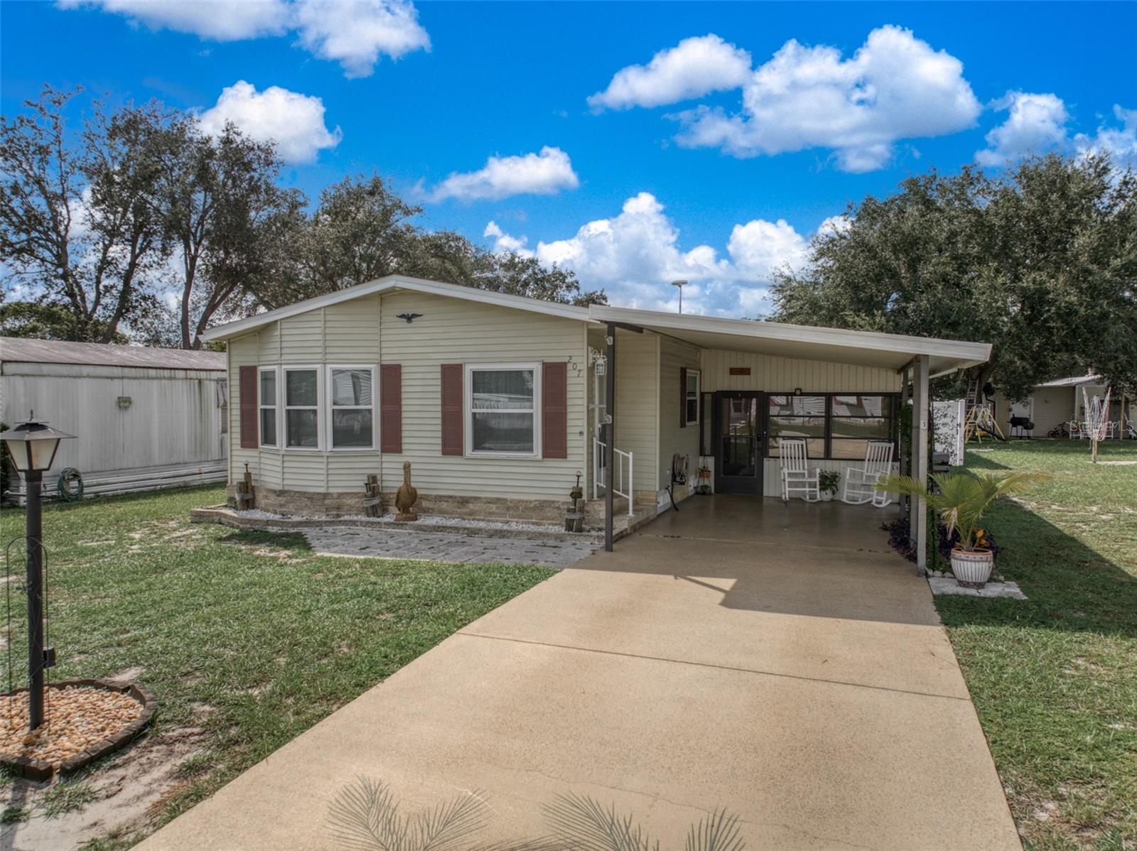 Charming 2 Bed, 2 Bath Home with a Beautifully Finished Florida Room

Welcome to this exceptional property in Avon Park, Florida! This delightful 2-bedroom, 2-bathroom home offers an array of features that make it truly stand out.

As you step inside, you'll be greeted by a spacious 15 x 23 living room, featuring new waterproof vinyl plank flooring and a stunning bay window that fills the room with natural light. This living space is perfect for entertaining or simply relaxing with family and friends.

The kitchen is a custom gem, complete with a unique kitchen table and two stools. Additionally, a bedroom set and dining room set can be included in the sale if desired by the buyer.

One of the distinctive features of this home is the laundry room, which includes a convenient small sink, adding extra functionality to your daily routines.

The roof, replaced in 2017, provides peace of mind for years to come. What's more, the windows come with a 100% transferable lifetime guarantee, ensuring both energy efficiency and long-term durability.

Storage space is abundant, with three large outdoor sheds on the property (two measuring 8x10 and one at 4x6). Whether you're a hobbyist or simply need extra space, you'll find these sheds invaluable.

Inside, the living room boasts a beautiful tongue and groove ceiling and aluminum custom blinds, adding to the home's charm and character.

For those who love the outdoors, the fully functional irrigation system makes lawn care a breeze. The fully fenced in backyard is a true retreat. A beautiful vinyl fence provides securtiy and privacy providing for a perfect outdoor getaway that features a variety of fruit trees, including mango, fig, olive, and a majestic fox palm tree - all included with the property.

Don't miss the opportunity to own this unique and well-maintained home with its numerous amenities and thoughtful details. Schedule a showing today to experience all that 207 S. Camphor Loop has to offer!