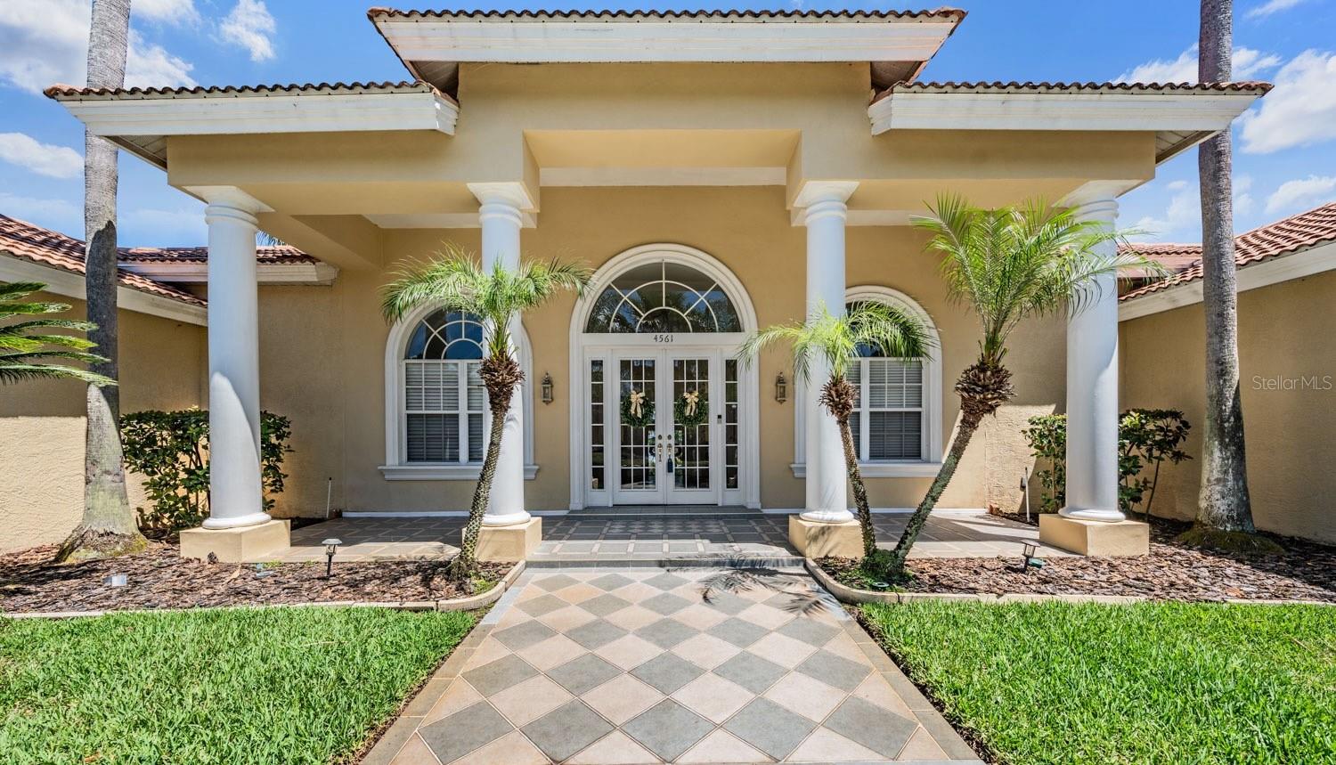 This uniquely designed custom Estate home in Robinwood at Lansbrook blends timeless architectural detail with peaceful pond and wooded views to create a truly private retreat. Thoughtfully designed with a split floor plan, the home offers 3 bedrooms plus an office with potential to be 4th bedroom or guest suite with French glass doors. Soaring ceilings, expansive windows, and abundant natural light enhance the open layout while showcasing tranquil views of the pool, pond, and surrounding wildlife. The updated kitchen features custom cabinetry, quartz countertops, stainless steel appliances, and a spacious breakfast nook overlooking the lanai and water views. The kitchen flows seamlessly into the inviting family room with a gas fireplace, creating an ideal space for everyday living and entertaining. The spacious primary suite offers elevated ceilings, a separate sitting area overlooking the pool and pond, dual walk-in closets, and a beautifully renovated spa-inspired bath complete with custom vanities, soaking tub, oversized shower, and built-in sauna. On the opposite side of the home, two additional updated bedrooms each feature their own bathrooms and direct access to the pool area. Resort-style outdoor living is equally impressive with a large screened lanai, tropical landscaping, private wooded backdrop, and serene pond views backing up to conversation/pond with no rear neighbors! A rare 4+ car garage provides exceptional space for vehicles, storage, hobbies, or recreational equipment. Numerous recent upgrades include renovated kitchen and bathrooms, luxury waterproof flooring, new carpet and tile, updated lighting and ceiling fans, newer front doors, rescreened lanai with pet-proof lower screens, pool heater, saltwater chlorinator, sprinkler system updates, water heater, hurricane shutters, and more. Lansbrook residents enjoy an exceptional lifestyle with miles of walking trails, parks, lakes, and access to the private Lake Tarpon park featuring a boat ramp, day slips, waterfront pavilion, playgrounds, and restrooms. The community also offers a sports park with basketball and soccer fields, nearby golf, highly rated schools, and convenient access to shopping, dining, beaches, and Tampa International Airport. With its extensive updates, flexible layout, tranquil setting, and exceptional Lansbrook amenities, this move-in ready home offers the perfect blend of luxury, comfort, and Florida lifestyle living.