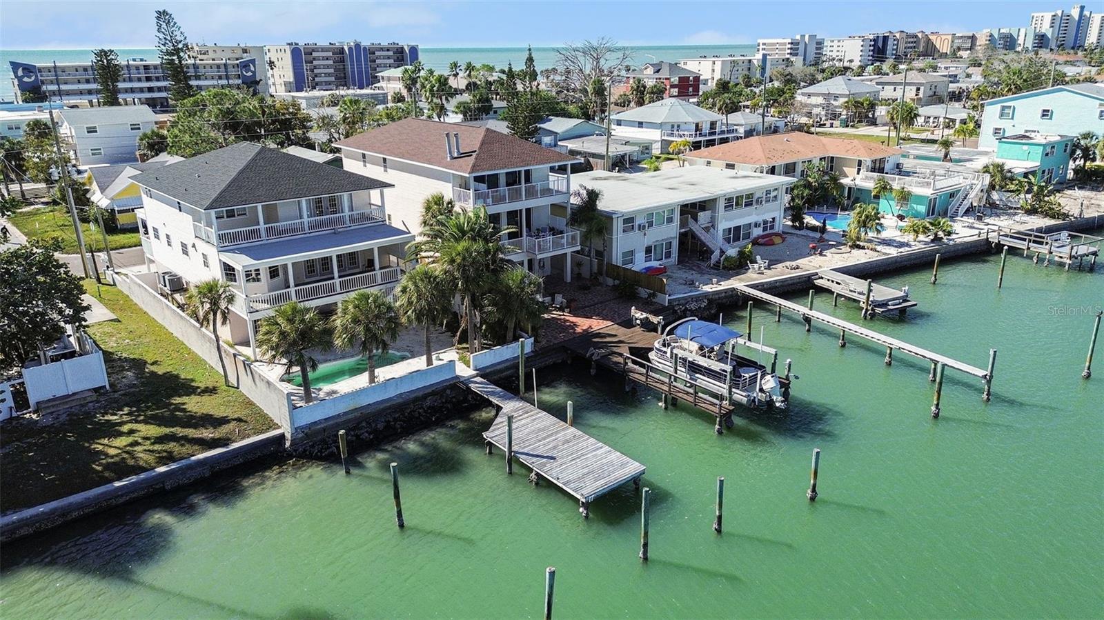Experience refined coastal luxury with sweeping views of the Gulf of Mexico. This elevated waterfront residence offers 3 bedrooms, 3.5 baths, TWO primary suites, an elevator, and a 3-car garage, thoughtfully designed for upscale living. The open-concept main level features a chef’s kitchen flowing seamlessly into the living and dining areas, all framed by breathtaking water views and abundant natural light.
The third-floor primary suite is a private retreat with its own balcony, two walk-in closets, and a spa-style bath with jacuzzi tub and walk-in shower. A second primary suite offers Gulf views, private balcony, and en-suite bath. Additional highlights include two wood-burning fireplaces, luxury vinyl flooring, and surround sound.
Enjoy effortless waterfront living with a brick paver yard, mature palms, private dock, and 10,000-lb boat lift with quick Gulf access. Watch dolphins, fish from your dock, and enjoy Madeira Beach fireworks from home. Recent updates include a 2023 roof and water heater, updated HVAC, fresh interior paint, dishwasher and refrigerator (2025). Just steps to the beach and minutes to John’s Pass, dining, and shopping—this is truly a boater’s paradise.