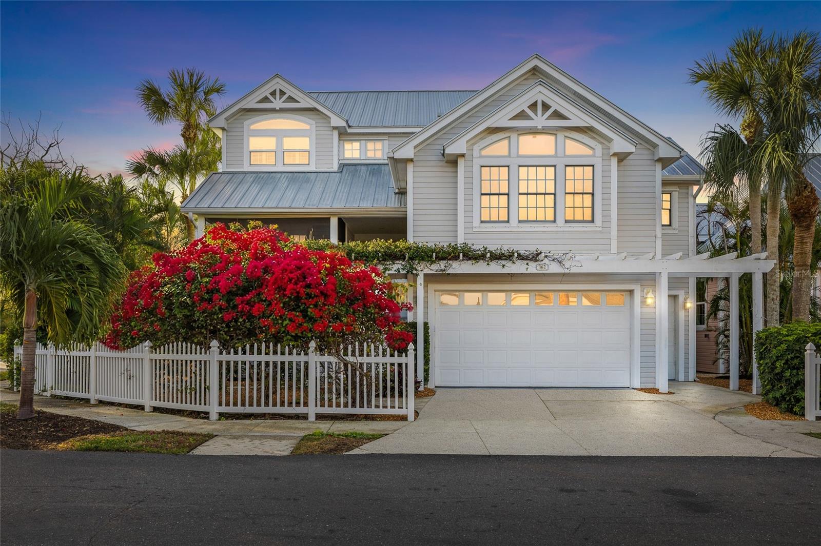 This well maintained in-town North Village residence in the private Boca Bay community offers 3 bedrooms, 3 full en-suite baths, and 2 additional half baths, framed by lush tropical landscaping and vibrant cascading bougainvillea. Thoughtfully designed for both comfort and functionality, the home includes a two-car plus golf cart garage, ample storage, and a back of the garage attached workshop – perfect for the avid craftsman or hobbyist with additional storage! Enjoy desirable southern exposure, bathing the home in warm natural light throughout the day. The interior has been tastefully upgraded with modern finishes and appliances. The kitchen features stainless steel appliances, granite countertops with matching backsplash, and updated custom cabinetry, opening seamlessly to a spacious living area ideal for entertaining. A wet bar with mini beverage refrigerator is complimented by a cozy sitting room, creating an inviting gathering space for friends and family. The home also offers a separate dining room with abundant natural light, an enclosed front porch, and an enclosed rear lanai leading to a lounge deck with stairs descending to a sparkling pool with spa, and expansive pavered deck – ideal for relaxing or hosting under the Florida sun. Backing to a tranquil nature preserve, the property enjoys added privacy and peaceful surroundings. As part of the Boca Bay community, you'll enjoy access to its premier amenities with exclusive membership in the Boca Bay Pass Club offering exceptional resort-style amenities including fine dining, 8 Har-Tru courts, four swimming pools including a lap pool, community boat docks, as well as access to the Boca Bay Beach Club – offering a complete coastal lifestyle. Whether you're looking for a primary residence or a seasonal getaway, this home offers the perfect place for indulging in all that Boca Grande has to offer. Walk into the Village and onto the beach – close to everything. Please come and see this well placed and well priced Home!