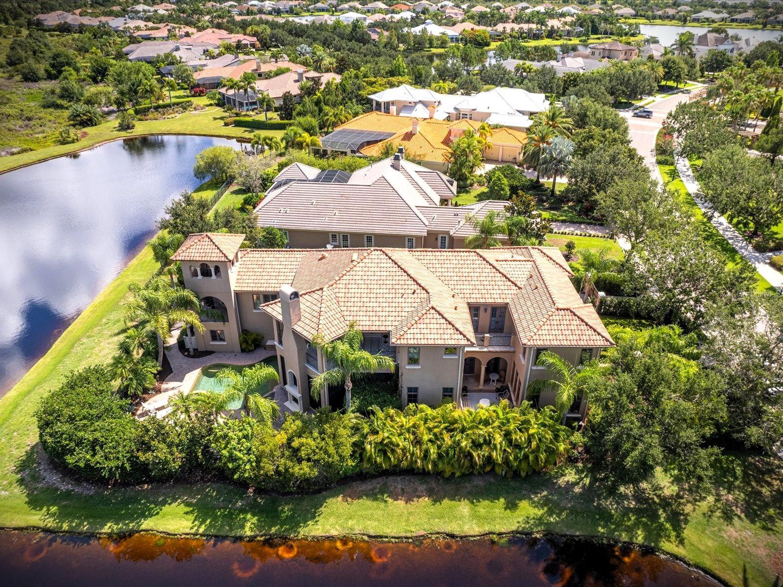 You can't always get what you want....but this house is definitely what you need!  Hamrick / Jagger
This magnificent, custom built Rutenburg home in the premier gated community of The Lake Club was built with privacy in mind. Exceptional lot with serene water views on two sides, a beautifully landscaped linear park across the street & only one neighbor. As you enter the front door you will be in awe of the unique architecture & attention to detail which defines this amazing house along with its unique history! Two sets of French Doors take you into a private courtyard surrounded by lush Florida landscaping for total peace & privacy.  5700+ sq feet of remodeled light & airy excellence, 4 en suite Bedrooms (all w/ walk in closets), 5.5 Baths, Study, Great Room, Den, and expansive entertaining media room w/ full wet bar & full bath perfectly situated on .35 of an acre (15,245 sq ft). 3 Balconies, screened Lanai & it's very own bell tower w/ spectacular sunset views complete the outdoor living. 2 professional decorators & $400K+ later this house is as comfortable as it is elegant and a must see. Newly screened in lanai with fireplace and kitchen is perfect for entertaining with a lovely view of the open-air Salt water, heated, Pool. Enjoy 12 ft ceilings w/ Crowne molding, dramatic coffered ceilings thru the great room & kitchen. This house has been completely remodeled by not one but two designers over the past 2 years.  Curated professional lighting, full interior painted, Pocket doors added, Dark wood lightened, & extensive landscaping, security cameras & gates added. Every chef's dream is this custom kitchen w/ Sub Zero, Viking, Wolf and Miele appliances, ample cabinetry, oversized island & 2 walk in pantries. Gas Viking stove, warming drawer, convection oven and a cappuccino machine make this kitchen perfect for gathering with friends and family. This oversized Owner's Suite is the perfect oasis at the end of the day with its private large balcony w/ fireplace and breathtaking backdrop water sceneries. New custom darkening remote powered window treatments, walk in closet and private staircase round out this elegant room. Impressive mast bath w/ dual granite vanities, soaking tub, and a lg walk in Rain Shower.  As a hidden bonus this house has an oversized Entertainment/Media room w/ a large wet bar, full bath & private staircase leading to it.  The possibilities for that room are endless. The more you explore this property the more you will fall in love!  Come Home to the gated community of the Lake Club (LWR most exclusive community) and enjoy an elevated life-style with its Newly remodeled 20,000 sq ft Grand Clubhouse, Resort Style Pools, private Tennis Courts, Dining, Social Activities and Fitness Center. Room Feature: Linen Closet In Bath (Primary Bedroom).