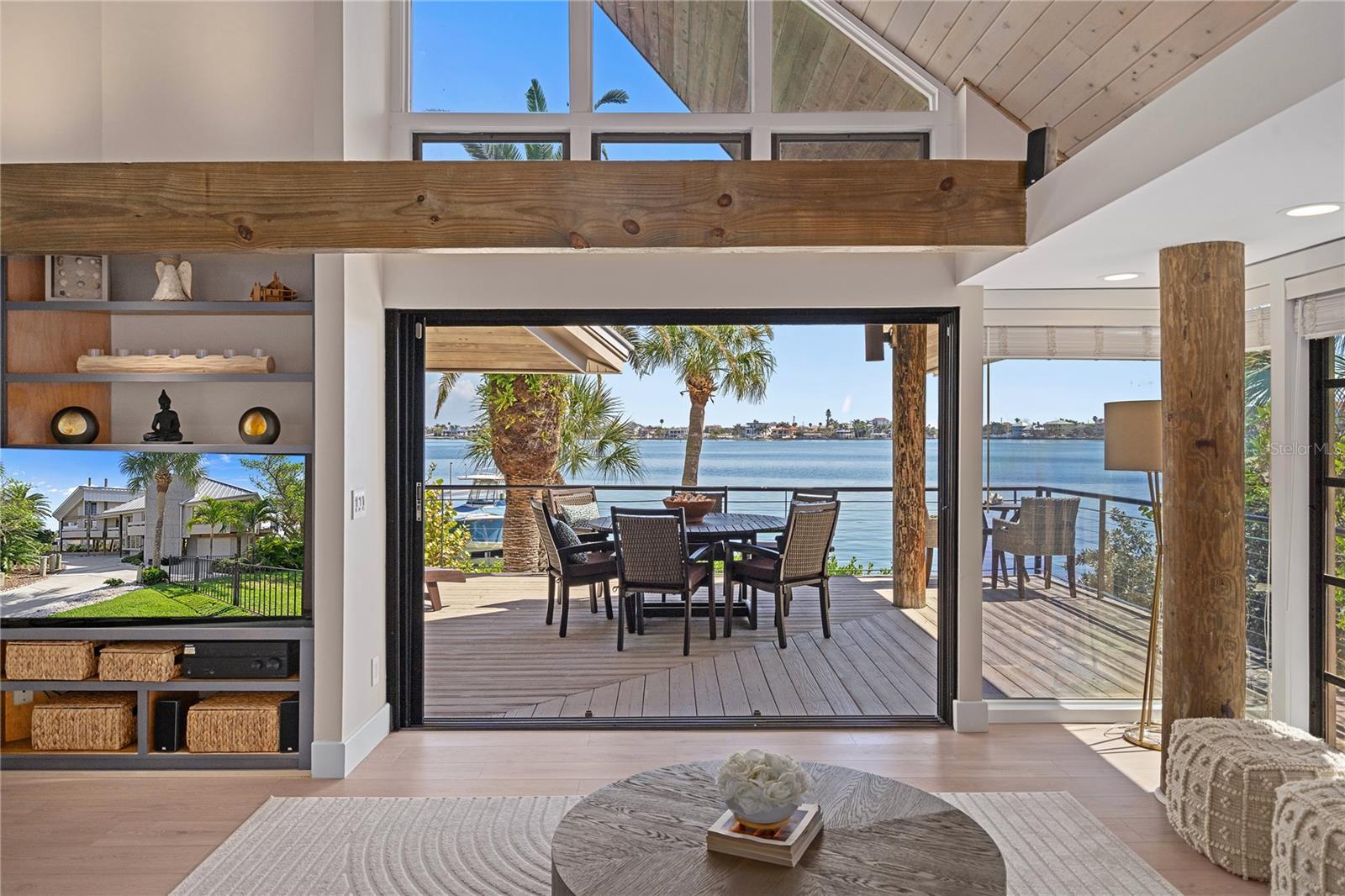 ***LOW FLOOD INSURANCE (quote attached) + TRANSFERABLE DRYWOOD TERMITE WARRANTY*** ICONIC & TURNKEY ELEVATED WATERFRONT LIVING WITH 180° SOUTH-FACING VIEWS OF BOCA CIEGA BAY IN ST. PETE BEACH Featured as “HOUSE OF THE WEEK” in the April 2026 edition of WSJ (Wall Street Journal). Originally designed and built by an architect, and later fully reimagined in 2024, this architect- and engineer-designed MASTERPIECE draws inspiration from the serene luxury resort of Soneva Fushi in The Maldives, blending TIMELESS DESIGN with MODERN COMFORT. Situated on the coveted shores of St. Pete Beach and nestled amidst LUSH NATIVE LANDSCAPING, it offers a rare blend of LUXURY, PRIVACY, and TRANQUILITY. This BEAUTIFULLY REMODELED 3BD / 3BA home with nearly 2,200 sq ft stands out for its wood finishes and sculptural form, which has been likened to a sailboat, featuring a split layout designed to MAXIMIZE LIGHT AND WATER VIEWS from nearly every angle and room. Showcasing SOARING CATHEDRAL and DOUBLE-HEIGHT CEILINGS, abundant NATURAL LIGHT, heavy TIMBER BEAMS, and an OPEN-CONCEPT LAYOUT that flows seamlessly from the main living area to an EXPANSIVE WATERFRONT BALCONY, the home feels both dramatic and welcoming. At its heart, a palm-filled central courtyard enhances the connection with nature and creates a serene focal point. Recent upgrades include NEW FLOORING, a REDESIGNED KITCHEN, and UPGRADED BATHROOMS, highlighted by a spa-inspired Primary Suite, along with a freestanding soaking tub, a RED-LIGHT THERAPY ROOM, and a ONE-OF-A-KIND attic-level PLAY AREA with a catamaran-like HAMMOCK and BUILT-IN BALL PIT. ALL SYSTEMS have been RECENTLY UPGRADED: AC (2020), Electrical panel (2024), 40-yr METAL ROOF (2013), NEW FASCIA & LEAF GUTTER-FILTER (2025). The lower level adds a 330 sq ft AIR-CONDITIONED BONUS WELLNESS or HANGOUT SPACE with a bathroom and outdoor shower (not included in the living square footage), while also enhancing the shaded first-floor OUTDOOR LIVING EXPERIENCE, including a COVERED COASTAL BREEZEWAY LOUNGE, creating a relaxed open-air retreat beneath the home. Enjoy 5 BALCONIES, each offering its own purpose and character for entertaining, relaxing, or taking in the water views, along with wraparound waterside decking, an adjoining roof deck, and ground-floor shaded patios. These spaces open to a private outdoor setting complete with LUSH LANDSCAPING, a PRIVATE SANDY BEACH, a 9-PERSON HOT TUB, a FIRE PIT, a CIRCULAR DRIVE, and a DOCK on deep water for boating enthusiasts, which can also be used as a fishing pier. The dock delivers the ULTIMATE WATERFRONT EXPERIENCE with a 26’ walkway, an expansive 10’ x 12’ platform with a built-in bench, a swim ladder, and dual mooring arms. Built with EXCEPTIONAL CRAFTSMANSHIP, the home has demonstrated remarkable resilience, with structural integrity evident throughout, and has WITHSTOOD ALL MAJOR HURRICANES. Ideally located just a SHORT WALK TO THE WHITE SANDY BEACHES of the Gulf and minutes from local favorites such as Sea Critters Cafe, Paradise Grille, Pass-a-Grille Beach, and the iconic Don CeSar, this beachside setting offers a CHARMING COASTAL LIFESTYLE that feels like a small village rich in history, with REFINED DINING and TIMELESS CHARACTER all around. => CALL/TEXT TODAY TO SCHEDULE YOUR PRIVATE SHOWING, AS THIS IS A RARE OPPORTUNITY TO OWN A DISTINCTIVE WATERFRONT PROPERTY COMBINING ARCHITECTURE, LIFESTYLE, LEGACY, AND LOCATION.