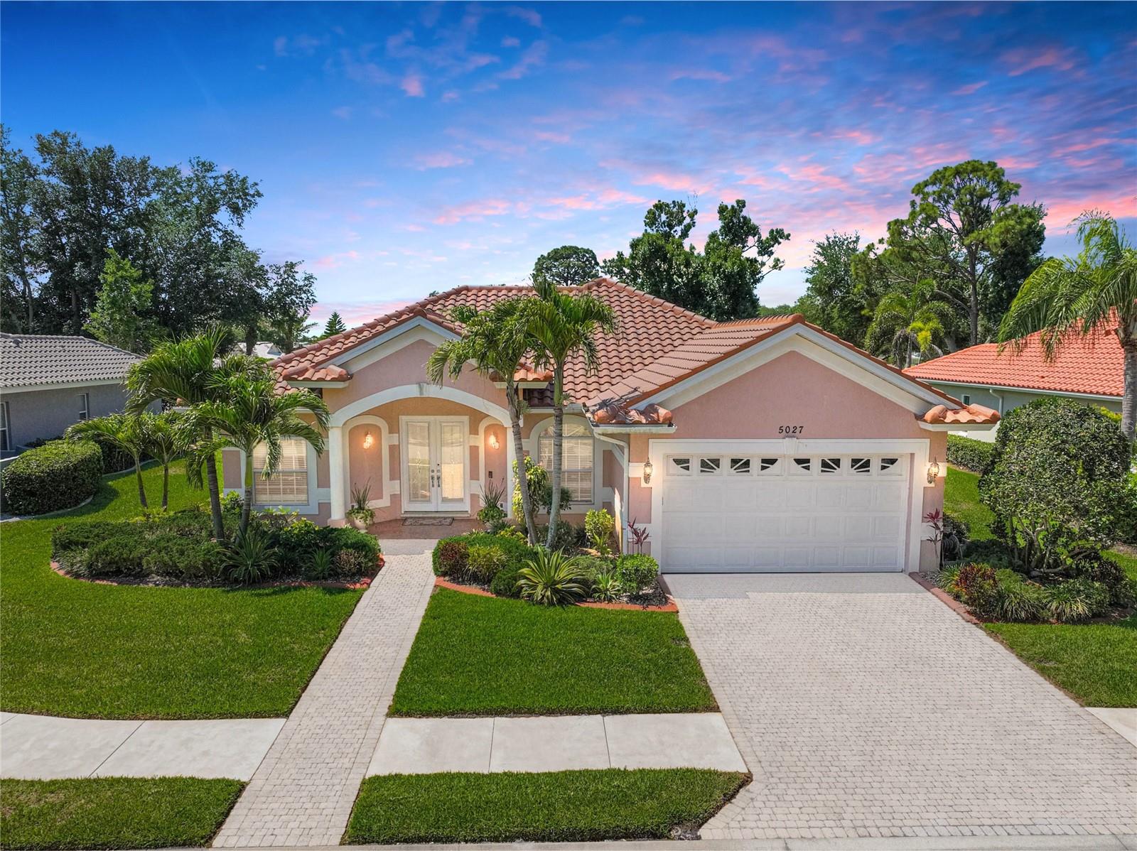 NEW AND IMPROVED PRICE! Set within the gated community of Venetia, this residence brings together thoughtful updates, natural light, and everyday livability in a setting that feels both welcoming and connected. From the moment you arrive, the curb appeal and upgraded decorative front doors create a warm first impression, while the park-like green space with mature trees just outside your front door adds a sense of calm and privacy. Step inside, and you’re immediately drawn to the light that fills the home and the easy, comfortable flow of the layout. Tray ceilings add dimension overhead, while the living room naturally becomes the gathering space—anchored by sliding glass doors that lead to the lanai and create that seamless indoor-outdoor connection Florida living is known for. With access from both the dinette and the primary suite, the lanai becomes a natural extension of the home—perfect for slow mornings or relaxed evenings. Just beyond the lanai, the backyard offers a simple, easy-to-enjoy outdoor space, with a tree that provides shade and a sense of quiet separation—comfortable, manageable, and just enough to enjoy without the upkeep of something larger. The kitchen is designed for real life, offering a true pantry, a breakfast bar with seating for two, and the rare convenience of two dishwashers. Just beyond, the dedicated dinette provides space for a table seating four, with its own access to the lanai, creating an easy flow for both casual meals and gatherings. Custom-made window treatments and valances are already in place throughout, adding a thoughtful, finished touch. Tucked privately away, the primary suite is filled with natural light and offers direct access to the lanai. The ensuite bath creates a quiet retreat, complete with a jetted tub and a separate water closet. Storage is well integrated throughout, with spacious closets and well-placed storage that make staying organized easy. The secondary bathroom includes a ceiling-mounted heat lamp for added comfort. This home has been carefully maintained and meaningfully updated, including a new roof (2025), new AC (2022), and upgrades to plumbing and flooring—giving you confidence in both the big and small details. Just across the street, guest parking makes it easy to welcome friends and family. Sidewalk-lined streets invite daily walks and a sense of connection throughout the neighborhood. Life in Venetia extends beyond your front door, with access to a clubhouse, resort-style pool and spa, fitness center, tennis and pickleball courts, and a full calendar of social activities. Shopping, dining, and everyday conveniences are right across the street. Located just minutes from Venice Beach, waterfront dining, and the charm of downtown Venice, this home offers a lifestyle that feels easy, connected, and distinctly coastal. Experience it for yourself with a private showing. ¤ Please see 3D Tour and Video ¤