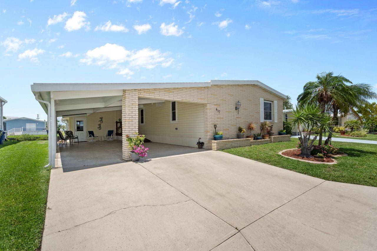 LARGE PRICE ADJUSTMENT! A very unique find within the 55+ GULF ACCESS community of Harbor Cove! This FURNISHED 2 bedroom, 2 bathroom, CANAL FRONT home with DOCK has approx. 1420 sq. ft., including an enclosed 220 sq. ft. Florida room with beautiful water views! Outside the brick front, extra large carport, plus attractive landscaping set the stage for what’s to follow. This well maintained residence in the PET SECTION is nicely updated and has a welcoming coastal vibe and décor. The kitchen has plenty of cabinetry and counter space, a breakfast bar, closet pantry, stainless steel appliances, an opening to the living room and a dining room with built in hutch nearby. Decide between dining and entertaining friends with stunning sunset views from the Florida room, the covered and screened lanai, or the waterfront patio. The large living room is nice and bright with plenty of windows and sliding doors direct to the Florida room. The impressive and spacious primary suite has a large walk-in closet and a remodeled ensuite bathroom with attractive cabinetry and tiled shower. The updated hall bathroom is handy for visitors staying in the well-appointed guest room with dual closets. You'll find lots of storage space in the attached shed with laundry area. Many recent UPDATES including new roof, vapor barrier, luxury vinyl flooring, and re-plumb (2025), hot water heater and washer and dryer (2024), A/C system and appliances (2022), plus impact windows and more. HOA fees of only $150 per month cover seawall maintenance, mowing and access to two swimming pools, hot tub, fitness center, sports courts and a 17,000 sq. ft. clubhouse overlooking the picturesque marina. Join the boat club and make friends at dances, holiday events, trivia, card games, golf cart parades and other organized events. Boating and fishing fans can just jump in their boat in the backyard and go explore the majestic Myakka River all the way to the Gulf. Nearby are restaurants, golf courses, spring training baseball stadiums, farmers markets, quality healthcare and several area beaches. Schedule a showing today to view this lovely property!
