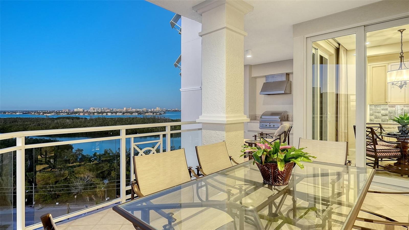 Extraordinary residence at the ORCHID BEACH CLUB…RENOVATED, DESIGNED and FURNISHED by award-winning SALLY TROUT DESIGNS. Ideally situated in one of the area’s most coveted locations, Lido Beach, with breathtaking panoramic views that stretch from the Gulf of Mexico to Sarasota Bay & the downtown Sarasota skyline. Meticulously designed & turnkey furnished, the nearly 3,000 sq. ft. of living space exudes sophistication and elegance. The grand foyer, accessed through a private elevator lobby, leads into a regal living area featuring extraordinary detailing. Three expansive terraces enhance the allure of this home, providing ample space for outdoor living and taking full advantage of the stunning views. The spacious living room features full height sliding doors leading to the main terrace, offering additional lounging, dining options, & gas grill. The chef’s kitchen has ample custom cabinetry, beautiful quartzite countertops & backsplash, top-of-the-line appliances, including Wolf 6-burner gas range, Wolf convection steam oven, Wolf built-in wall oven, Miele coffee maker, Cove dishwasher & Sub-Zero refrigerator. The breakfast bar & adjoining breakfast nook with built-in dry bar provide casual seating. Double doors lead to the grand primary suite, with views of the Gulf, terrace access, 2 outfitted walk-in closets, morning bar, spa-inspired ensuite bathroom with separate vanities, a large walk-in shower & freestanding soaking tub. Two additional bedrooms (one outfitted as an office); each with direct access to terraces, & two beautifully finished full baths. Just a few of the designer features; custom built-ins in all closets, stylish light fixtures & recessed lighting w/Lutron wireless home control, 24” porcelain tile flooring, all upgraded cabinetry, custom drapes & shades (some remote closing), beautiful furnishings & original art, & whole-house water filtration system. Two spacious parking spaces convenient to elevator. Orchid Beach Club is a private, resort-style community with only 54 residences in two residential buildings, 24/7 guarded gate entrance & concierge. World-class amenities include a beach-side heated pool & spa with cabanas, a fully equipped clubhouse with social rooms, game room, library, fitness center, saunas, & 2 beautifully appointed guest suites for visiting family and friends. A pet-friendly community w/ private dog run. Located just minutes from St. Armand's Circle & downtown Sarasota, Orchid Beach Club offers a serene, private retreat while providing easy access to shopping, dining, and cultural attractions. Sophisticated but comfortable Florida living.