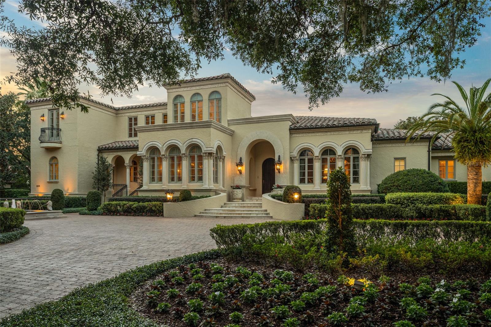 Located within the gates of the Isleworth Golf and Country Club community, this 7,821 square foot estate presents you with breathtaking views of the 8th fairway and glistening Lake Bessie.  The interior boasts features such as Venetian plaster walls, custom woodwork accents, marble & travertine floors, and vaulted ceilings. 
The living spaces have been thoughtfully designed with built-ins that provide both functionality and style. In the central gourmet kitchen, you’ll be equipped with top-of-the-line Subzero appliances, along with a bar and butler station conveniently located nearby.  The spacious gym offers the perfect opportunity to stay fit and healthy within the confines of your own estate.  With 5 bedrooms, 5 full bathrooms, and 2 half bathrooms, this estate offers a level of comfort and grandeur with a sprawling bonus / game room upstairs.
Outside, you'll find a resort-like oasis complete with a sparkling pool and soothing hot tubs, alongside an outdoor kitchen and grill.  The expansive 7+ car garage, a rare find, ensures that your prized automobile collection is readily available.