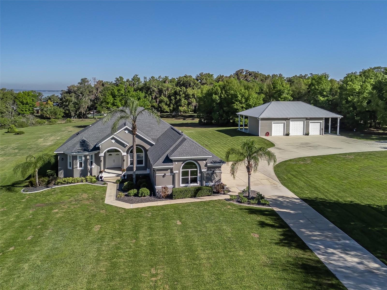 NOW OFFERED UNDER $1M~LOVELY HOME IN PRIVATE GATED LAKE WEIR COMMUNITY ON 2.25 ACRES JUST MINUTES TO THE VILLAGES & FLORIDA HORSE PARK. This beautifully updated property offers the perfect blend of space, privacy and convenience. This property is perfect for someone wanting elbow room to spread out without sacrificing proximity to everyday essentials~Shopping, Dining, Hospitals, Entertainment & more!
inside and out the home has been extensively updated, including new roof, fresh interior and exterior paint, new flooring, and upgraded appliances.  Major systems like A/C, Wate Heater, whole house water treatment and irrigation have all been taken care of.  
Step outside to your own resort~style pool area, complete with waterfall feature, spa, outdoor kitchen, large pool deck, new pool equipment and new grill~ perfect for entertaining or unwinding in total privacy. Seamless sliding doors open to the outdoors, creating a true Florida lifestyle experience. 
This property also features a large shop, endless storage, and ample space for RVs, Boats, and equipment. Property includes 2 boat slips.
It's a charming place to live!