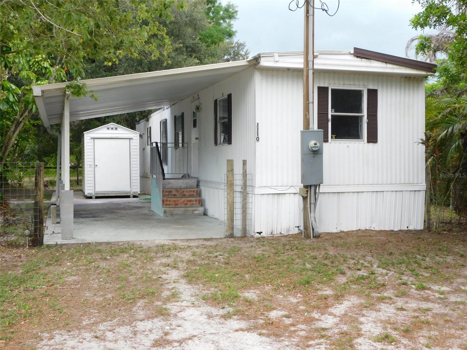 Mini ranch for $129,000. Fenced, has a pony barn, crossed fenced, pasture has trees, property has a thicket of trees in the back giving privacy to the property. Paved street on east and west side of the property. Variety of trees including cypress, mulberry,  palms, oaks, hedging. Single wide 2 bedroom 1 bath 1981 manufacturer home. Home needs work including some flooring. Covered and open patios. All this located on 1.25 acres of land. Yes, work is needed, and the reduced price reflects that.