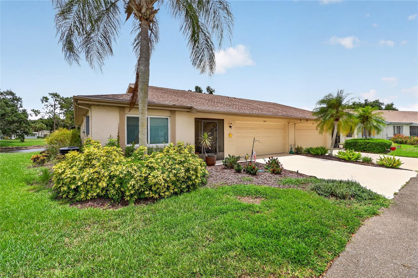 Welcome to Kings Point! This beautifully maintained and updated Sunrise floor plan offers 2 bedrooms and 2 full baths with peaceful, picturesque pond views from almost every room. The heart of the home is the light and bright kitchen, featuring freshly painted cabinetry, updated flooring, a modern light fixture, and a sunny breakfast nook. Open the sliding glass doors from the kitchen, the spacious living room, or the primary suite to access the oversized, screened, and covered lanai—the ultimate spot for morning coffee or relaxing Florida evenings. The split-bedroom layout includes a primary bedroom with a generous walk-in closet, a dedicated interior laundry room, and excellent storage with a rare foyer closet and a hallway linen closet. Bedroom 2 has a pocket door that when closed creates a private guest suite. Located in a premier, resort-style gated community, Kings Point features world-class facilities, multiple pools, fitness centers, and active social clubs. Situated perfectly between Tampa and Sarasota, you are just a short drive from award-winning Gulf beaches, international airports, professional sports, luxury shopping, and fine dining. Schedule your private tour today!