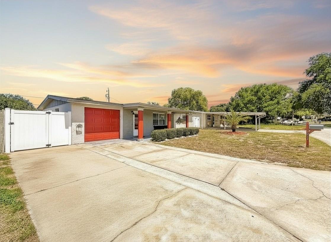 Virtually Staged. ***Seller will consider installing a NEW ROOF prior to closing with an acceptable offer.***Adorable block construction home, updated, and move-in ready! This immaculate 2-bedroom, 1-bath home with 1 car garage offers a versatile 14x12 BONUS ROOM with French Doors that is independently cooled for added comfort. The bonus room is ideal as a potential 3RD BEDROOM, home office, gym, playroom, or even a spacious formal dining room perfect for holiday gatherings and entertaining. NO HOA, NO CDD. The inviting living room showcases wood-like engineered laminate flooring, a chic and vibrant custom wood plank accent wall, and a large 75-inch SAMSUNG TV that conveys with the home. The beautifully updated bath features a custom barn door, granite vanity, updated shower, and a new hurricane impact-rated window. Enjoy a stylish kitchen with granite countertops, tile backsplash, new luxury laminate flooring, stainless steel appliances, built-in oven, and ample storage. Both bedrooms are spacious and feature newer waterproof Pergo XP+ wood-like flooring.  Outside, you'll find a large extended DOUBLE DRIVEWAY with ample parking for vehicles, boats, and RVs, a covered front patio, a large and fully fenced backyard, and a storage shed with electric!  Additional updates include a NEW water heater (2026), fresh exterior paint (2026), NEW Electrical Panel (2020), NEW plumbing (2018), NEW side garage door (2025), newer windows, Ring Doorbell, and a smart garage door opener.  Roof 2013. Conveniently located near shopping, dining, medical facilities, parks, beaches, and just minutes from downtown Tarpon Springs and all it has to offer. Whether you're looking for a primary residence or an investment opportunity, this lovely home is ready to meet your needs. Schedule your private showing today before this charming home is gone! You will love what you see!