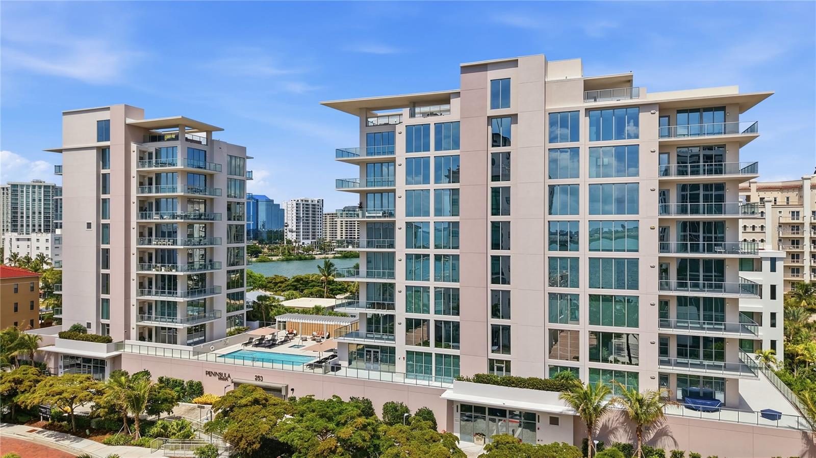 Newly completed, Peninsula Sarasota is ideally positioned in the coveted Golden Gate Point neighborhood, offering a peaceful residential retreat just moments from the vibrancy of downtown Sarasota. Designed by Blu Interiors, each residence showcases contemporary modern elegance with calming, sophisticated palettes, soaring ceilings, and expansive wraparound terraces that seamlessly blend indoor and outdoor living. Every element reflects a thoughtful commitment to refined luxury. State-of-the-art kitchens feature sleek European cabinetry, gas cooktops, and quartz countertops, complemented by premium Wolf and Sub-Zero appliances. Additional highlights include hardwood flooring throughout, floor-to-ceiling windows that flood the home with natural light, and a private terrace equipped with a gas grill—perfect for effortless entertaining. The spacious owner’s retreat serves as a true sanctuary, complete with a generous walk-in closet, dual vanities, a soaking tub, and an oversized walk-in shower for spa-like relaxation. Residents enjoy on-site concierge services and secure, access-controlled underground parking for two vehicles, including an EV charging station. A private foyer and dedicated elevator provide direct access to exceptional amenities such as a resort-style pool and state-of-the-art fitness center, while the elegant owner’s club room offers private wine storage for each residence. The communal rooftop terrace sets the stage for unforgettable gatherings, boasting sweeping panoramic and sunset views. Peninsula Sarasota delivers a truly elevated lifestyle within a lush, tropical setting—just minutes from Sarasota’s celebrated arts, culture, dining, and award-winning beaches. A rare opportunity to experience sophisticated coastal living. Schedule your tour today!