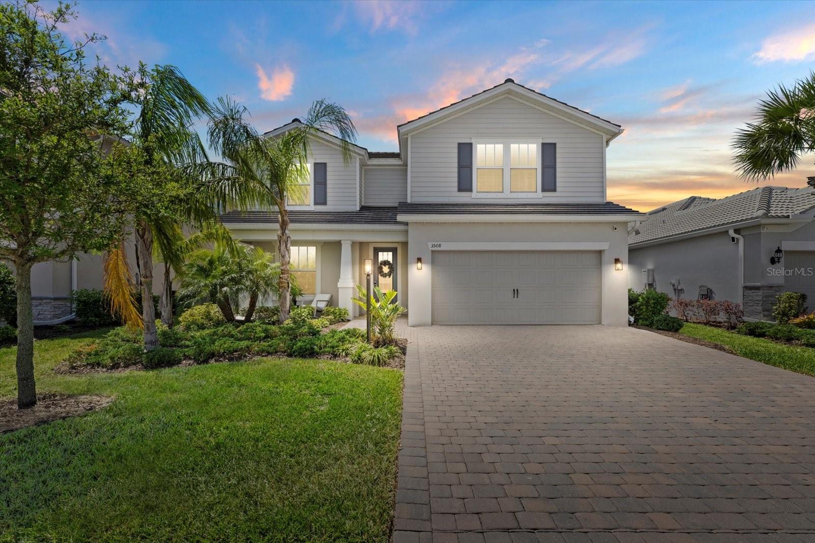 Stylish and sleek modern coastal living awaits in the highly sought-after community of Mallory Park, where luxury, comfort, and lifestyle come together in one exceptional home. From the moment you arrive, the charming covered front porch sets the tone for relaxed Florida living.

Inside, the thoughtfully designed open-concept floor plan is filled with upscale finishes and modern elegance. The spacious great room serves as the heart of the home, featuring sleek plank tile flooring, a stunning fireplace feature wall, and expansive pocket sliding glass doors that create a seamless indoor-outdoor experience. The custom-designed kitchen is built for both entertaining and everyday living with premium Samsung appliances, an oversized island, walk-in pantry, beverage bar, and abundant storage.

The main-level primary suite offers a private retreat with a spa-inspired bathroom, oversized walk-in shower, and custom-built walk-in closet. A dedicated home office, spacious laundry room, and garage with premium epoxy flooring and dual EV chargers add both convenience and functionality. Upstairs, the oversized loft/flex space offers endless possibilities as a media room, game room, or additional gathering space. A private guest suite with en-suite bath and walk-in closet provides comfort for visitors, while two additional spacious bedrooms feature walk-in closets and a shared bathroom.

Step outside into your own backyard oasis where the covered lanai, custom pool and spa, and expansive paver deck create the ultimate setting for entertaining or simply relaxing while enjoying breathtaking Florida sunsets. The lanai is also pre-plumbed for a future outdoor kitchen, making it ideal for hosting family and friends year-round.

Living in Mallory Park means enjoying a true resort-style lifestyle. Residents have access to a community clubhouse, sparkling resort pool and hot tub, fitness center, pickleball and basketball courts, playgrounds, fire pits, walking trails, and beautifully maintained green spaces designed for gathering and connection. The community also offers direct walking path access to Gullett Elementary School and Dr. Mona Jain Middle School, along with easy access to Bob Gardner Park for outdoor recreation and family activities.

Perfectly located near Lakewood Ranch Main Street, Waterside Place, and The Mall at University Town Center, this home offers convenient access to dining, shopping, entertainment, and top-rated golf courses, while nearby I-75 provides an easy commute to Sarasota, Bradenton, St. Petersburg, Tampa, and Orlando. Best of all, the world-famous Gulf Coast beaches are just a short drive away.

This is more than a home, it’s a luxury coastal lifestyle in one of the nation’s premier master-planned communities.