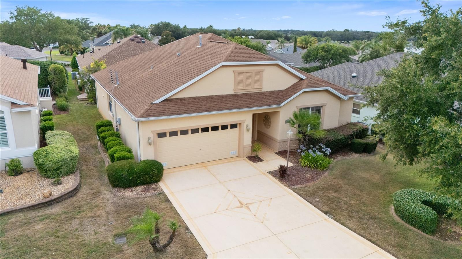 **BOND PAID • NEW ROOF JUNE 2026 • CUL-DE-SAC LOCATION • MINUTES TO LAKE SUMTER LANDING**Welcome to this beautifully maintained **Bridgeport Model** nestled on a quiet cul-de-sac in the highly sought-after **Village of Mallory Square**. Offering **3 bedrooms, 2½ baths**, soaring **10-foot ceilings**, and a spacious, thoughtfully designed floor plan, this exceptional home combines comfort, quality updates, and an unbeatable location. A welcoming foyer with convenient half bath opens into the main living area, where engineered hardwood flooring and volume ceilings create a bright and inviting atmosphere. The spacious living room features a custom credenza with electric fireplace, providing a warm focal point for relaxing or entertaining. The large eat-in kitchen is designed for both functionality and style, featuring tile flooring, an abundance of raised-panel maple cabinetry with roll-out shelving, solid-surface countertops, center island, built-in desk, breakfast bar, and generous workspace for preparing meals and gathering with family and friends. The primary suite offers a private retreat with a spacious walk-in closet and an en-suite bath featuring a Roman shower. The guest wing provides privacy for visitors with two additional bedrooms connected by a Jack-and-Jill bath. One guest room includes a Murphy bed, while the third bedroom offers flexibility as a home office, hobby room, or additional guest space. Enjoy Florida living year-round in the large enclosed lanai, offering privacy and additional living space. The outdoor patio provides the perfect setting for grilling, and enjoying the beautiful Florida weather. HVAC replaced 2024. Hot Water Heater replaced 5 years ago. The 2 car garage with 10 Foot ceilings.  Attic has pull down staircase and ample storage. Located just minutes from **Lake Sumter Landing Market Square**, residents enjoy convenient access to shopping, dining, entertainment, and nightly live music. Golf enthusiasts will appreciate the proximity to **Mallory Hill Country Club** and championship golf courses. Experience the unparalleled lifestyle that has made **The Villages** one of Florida's most desirable communities, offering endless recreation, clubs, golf, pools, pickleball, tennis, and social activities. This move-in-ready home offers the perfect combination of location, space, and lifestyle waiting to be embraced!