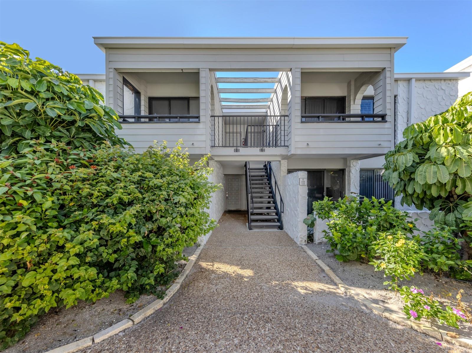 One or more photo(s) has been virtually staged. Experience coastal living at Bahia Vista Gulf, a sought-after condominium community on Venice Island along the Gulf. This two-bedroom, two-bath residence offers 934 square feet of thoughtfully designed living space with an open floor plan ideal for relaxed entertaining. The great room features sliding doors that open to a private front patio, while the dining area off the kitchen is just a short distance above, adding architectural interest and functionality. The kitchen extends to a patio for outdoor dining, and the primary suite includes a spacious walk-in closet. Ceramic tile floors flow throughout and both baths have been updated. Two lanais provide seamless access to the resort-style community pool and beach. Multiple decks offer areas to lounge, dine or gather with neighbors amid lush garden surroundings. Bahia Vista Gulf is just a short distance to the South Jetty and the Crow's Nest restaurant. Residents enjoy proximity to historic downtown Venice, known for its boutique shopping, dining, theatre and entertainment venues. Bahia Vista Gulf is a great rental complex as well, with a one-month minimum, 12 times a year.