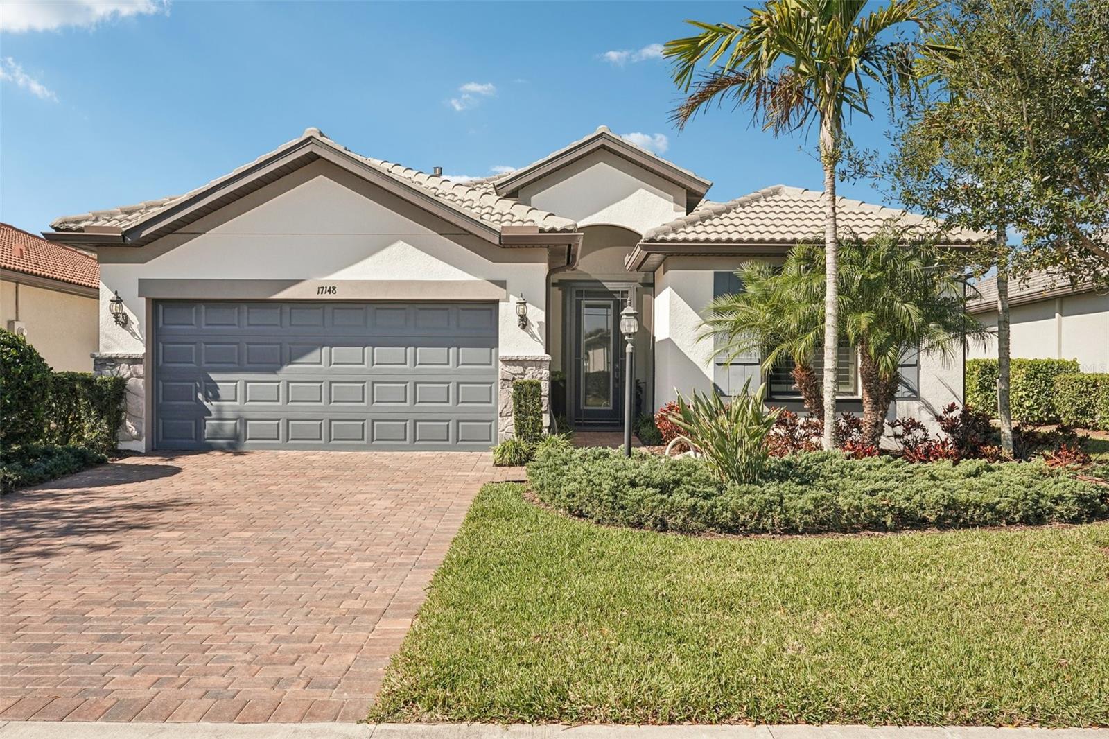 Welcome to 17148 Hampton Falls Terrace, a beautifully appointed home in Lakewood Ranch premier 55+ Del Webb community. This 2-bedroom, 2-bath residence offers nearly 1,900 square feet of open-concept living, and a bonus space for a den/office, extended screened lanai with a hood vented outdoor kitchen and upscale finishes throughout. Extended garage with epoxy floor, hurricane shutters and much more. (See attached Feature sheet and upgrades) Enjoy resort-style amenities including a clubhouse, fitness center, heated pool, and pickleball courts—all just steps from your door. With low-maintenance living, gated security, and a vibrant calendar of social events, this home delivers the perfect blend of comfort, connection, and convenience in Lakewood Ranch’s most active adult neighborhood. Come and take a look and make this house your home.
