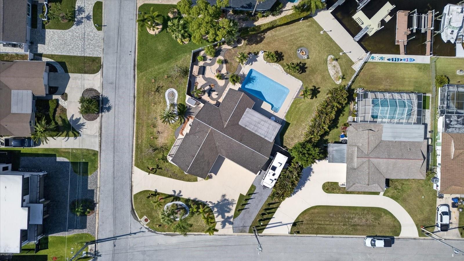 Virtually Staged. Views! Views! Views! Welcome to waterfront paradise in the highly sought-after community of Gulf Harbors! Perfectly positioned on an oversized .36-acre lot on the corner of a quiet cul-de-sac street, this immaculate waterfront pool home offers the ultimate Florida waterfront/boating lifestyle with 50 feet of seawall, a 10,000 lb. boat lift with adjacent finger pier, floating dock, kayak launch, and an extra-wide deep-water canal just moments from the open Gulf. This beautifully updated 2 bedroom, 2 bathroom, 2-car garage residence offers 1,895 sq ft of light-filled living space with a spacious split-bedroom floor plan designed for both comfort and privacy. From the moment you enter, you’ll be drawn to the stunning water views visible from multiple areas throughout the home. The all-new kitchen is a showstopper featuring custom cabinetry, quartz countertops, stainless steel appliances, abundant storage, and picturesque pool and canal views that perfectly complement the bright coastal feel of the home. Extensive updates completed in 2024-2025 include a full interior renovation and HVAC system, while the roof was replaced in 2011, garage door in 2017, front entry door in 2018 and select windows in 2019. Step outside and experience your own private tropical oasis. The beautifully landscaped grounds showcase Hong Kong Orchid trees, elegant Italian Cypress and Foxtail Palms lining the primary and supplemental driveways, and lush Areca Palms, clumping bamboo and hedges creating nearly complete privacy along the fence lines. Relax and unwind in the tranquil Zen garden featuring a brand-new double swing and winding stone pathways, or entertain poolside beside the large, gorgeous saltwater swimming pool. A cozy firepit area near the water creates the perfect setting for cooler Florida evenings under the stars. The oversized curved driveway offers ample parking for family and guests alike, with a supplemental stone driveway designed to host boat, trailer or RV parking/storage. Gulf Harbors is one of Florida’s hidden gems, offering residents an exceptional coastal lifestyle with optional access to two private boat ramps, an active civic association, and the exclusive residents-only Gulf Harbors Beach Club for just $200 per year. Enjoy 1/4 mile of private white sandy beach complete with cabanas, grills, lounge chairs, and beach bathrooms. This golf-cart-friendly community is conveniently located just minutes from vibrant downtown New Port Richey featuring waterfront dining, local boutiques, breweries, entertainment, Sims Park, pickleball courts, fitness centers, and more. This move-in ready waterfront retreat truly combines luxury, tranquility, and direct Gulf access in one extraordinary property. Start living the salt life you’ve been dreaming of today!