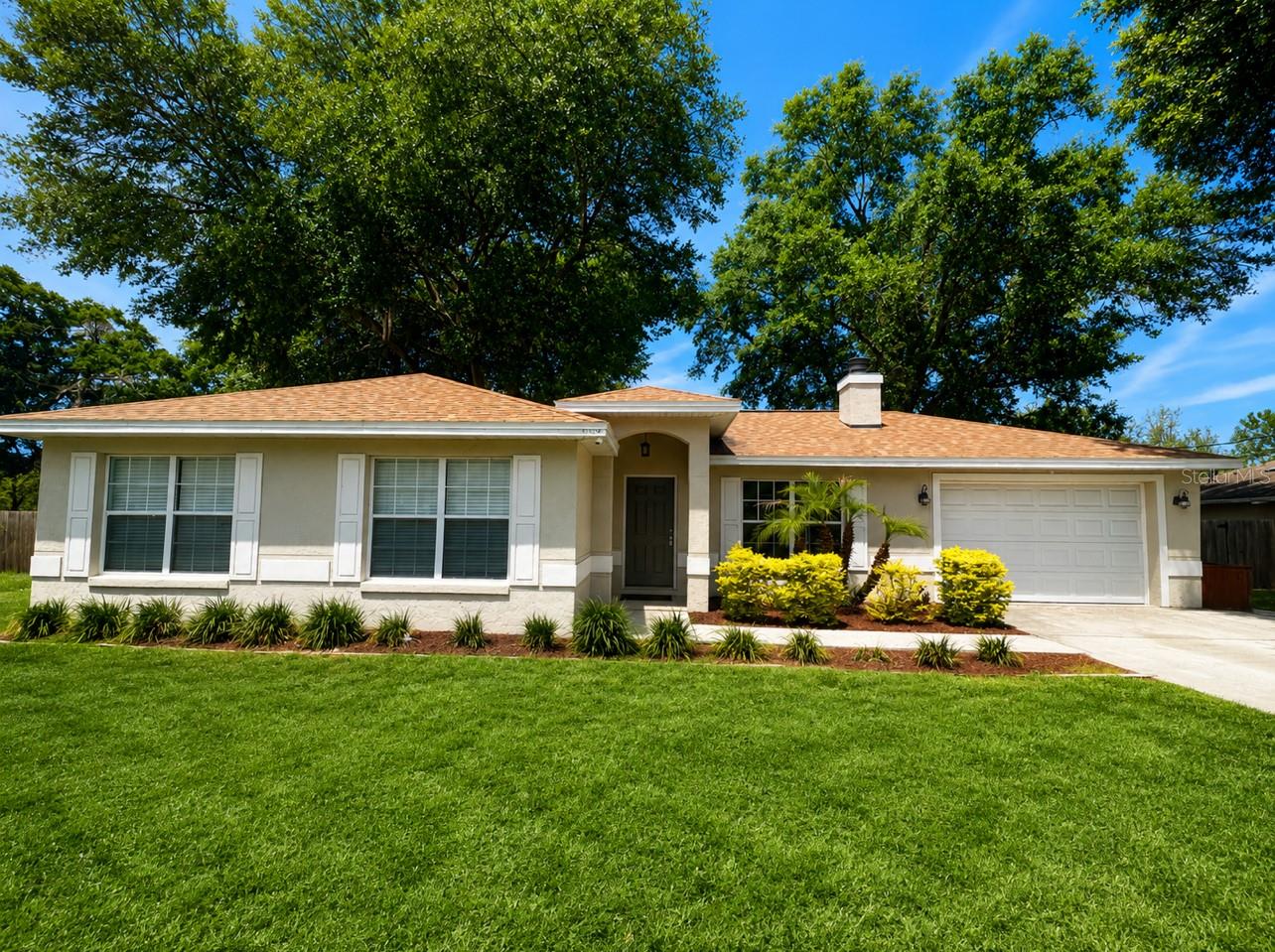 Welcome to this beautifully maintained 3-bedroom, 2-bathroom home featuring tile flooring throughout for easy maintenance and a seamless flow from room to room. The spacious kitchen is equipped with stainless-steel appliances, white cabinetry, a subway tile backsplash, breakfast bar, farmhouse sink, and abundant counter space, making it ideal for both everyday living and entertaining.

Enjoy Florida living year-round in the spacious screened lanai with tile flooring and direct access from the main living area through large sliding glass doors. The fully fenced backyard offers privacy and plenty of room for pets, play, gardening, or outdoor gatherings, all surrounded by mature shade trees.

Recent major upgrades provide added peace of mind, including a new roof installed in 2022 and a 3-ton Bryant 14 SEER HVAC system installed in 2021. Septic recently got pumped and the drainfield was replaced in 2023.

With its functional layout, inviting indoor-outdoor living spaces, and generously sized backyard, this home is the perfect combination of comfort, convenience, and Florida charm. Don't miss your opportunity to own this move-in-ready home—call today to schedule your private tour!
